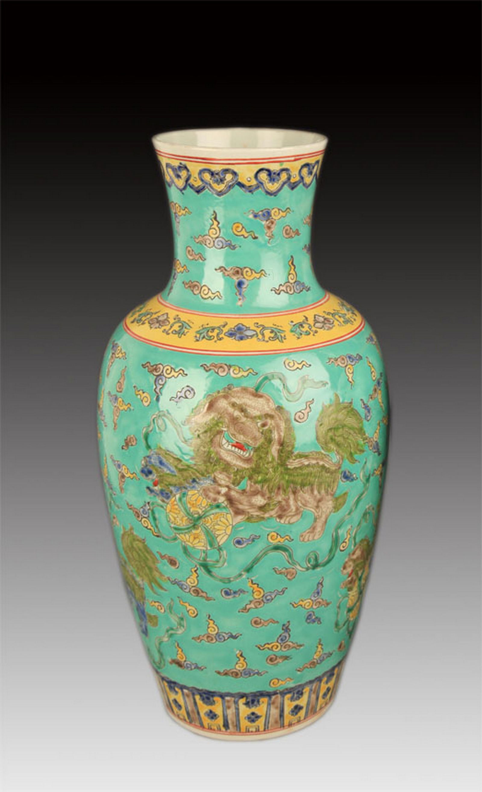 A GREEN GROUND FAMILLE VERTE LION PLAYING PORCELAIN VASE: Qing Dynasty; High: 16.25 inch Diameter: 4.25 inch