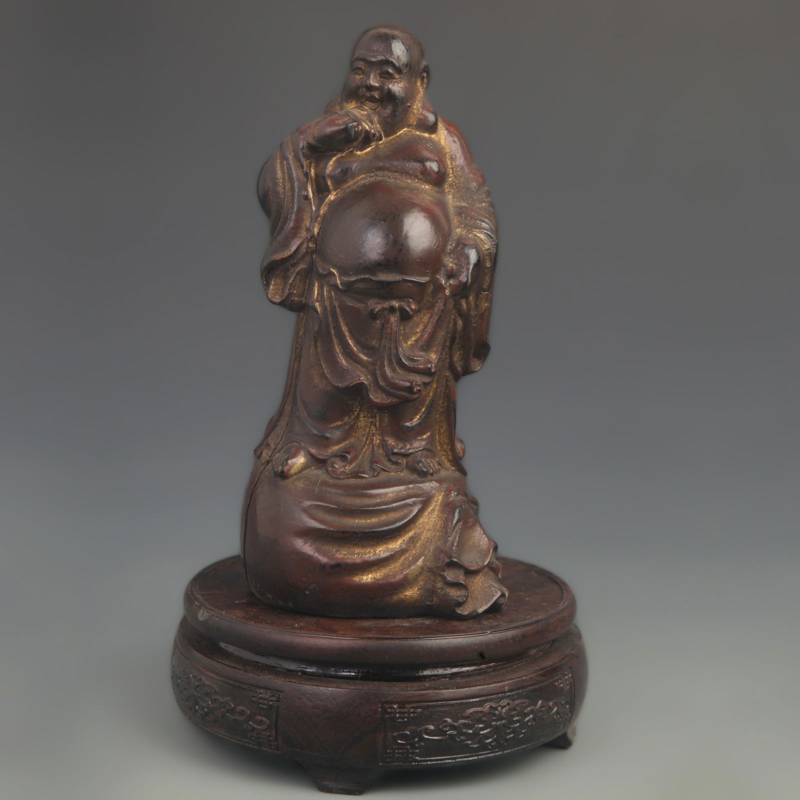 A FINE GOLD PAINTED WOODEN STATUE OF HOTEI (LAUGHING BUDDHA): 20th Century; High: 7.75 inch; Width:3.50 inch