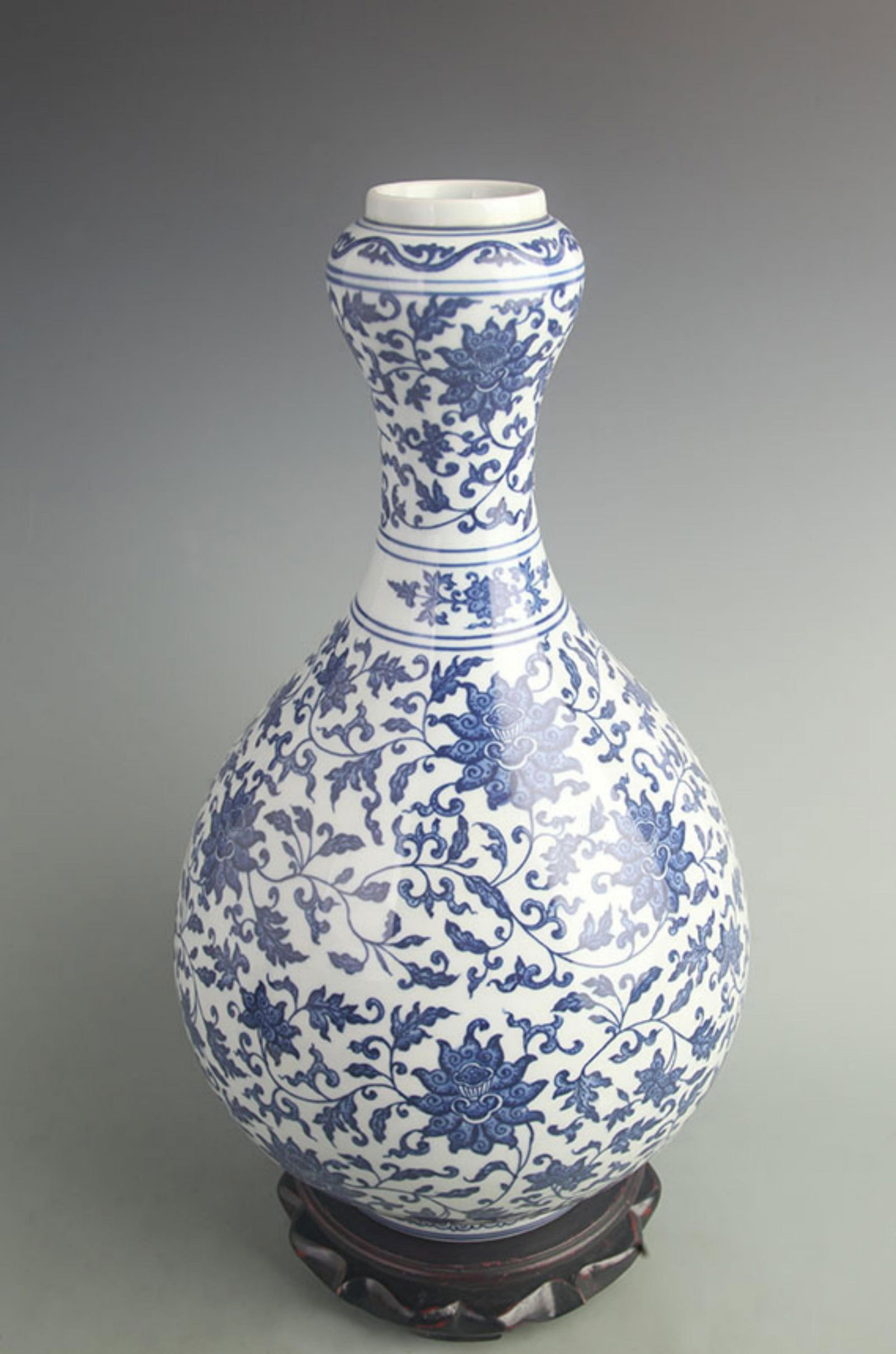 BLUE AND WHITE INTERTWINED BRANCHES LOTUS GARLIC HEAD PORCELAIN VASE: Qing Dynasty Qian Long Period; High: 17.0 inch; Width: 9.50 inch