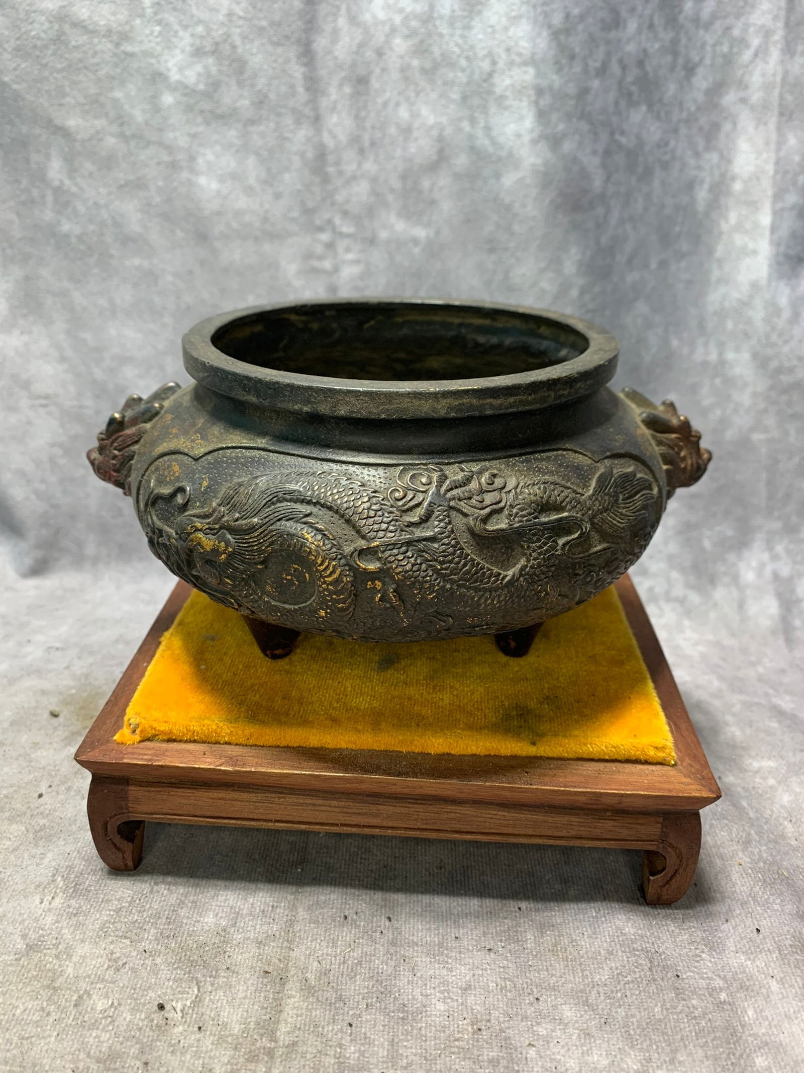 XUANDE ERA GILT BRONZE THREE-LEGGED CENSER WITH LION HANDLES AND DRAGON PATTERNS: Ming Dynasty; High: 3.5 inch; Diameter: 7 inch;
