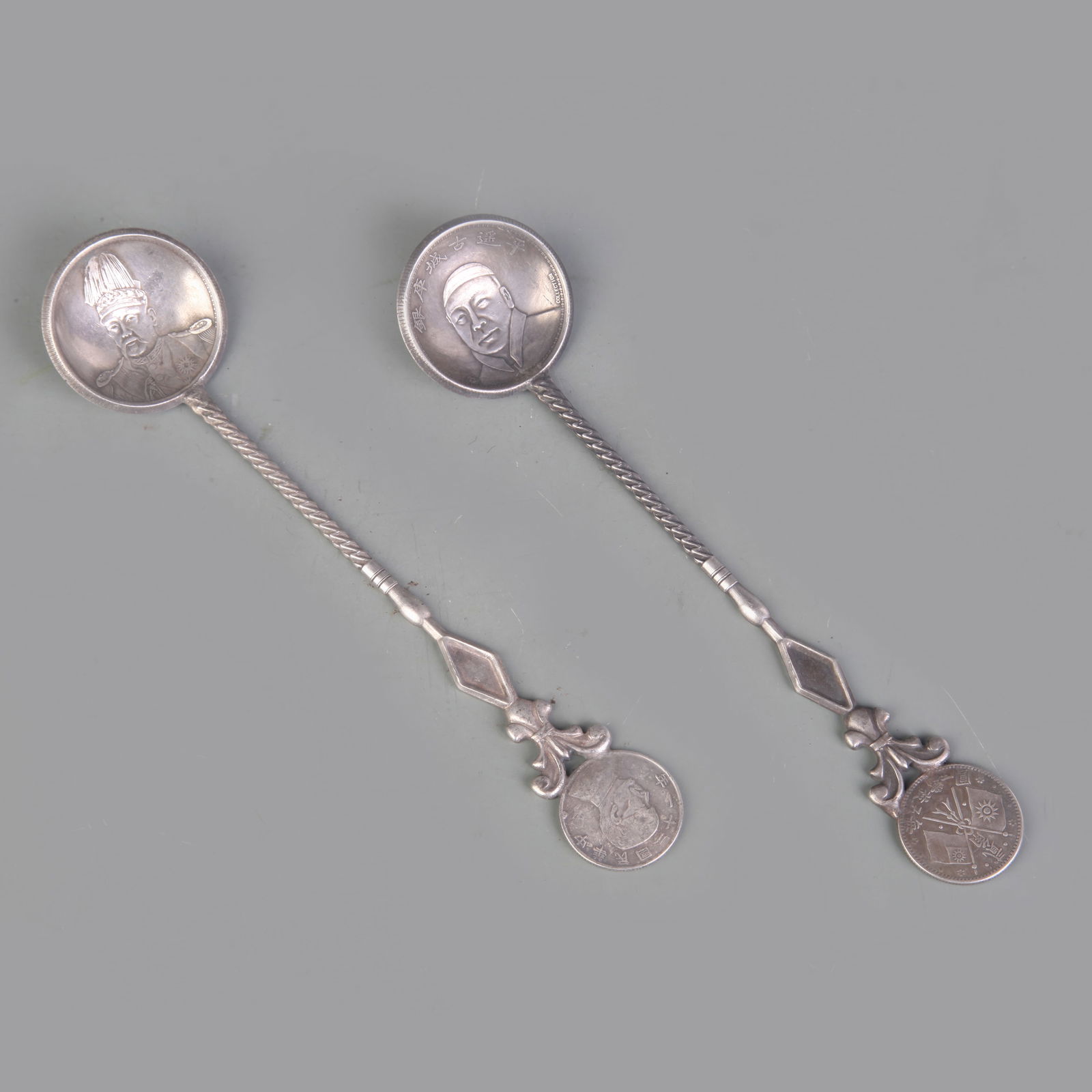 PAIR OF COIN STYLE SILVER PLATED SPOONS: Republic Period; Long: 6.9 inch