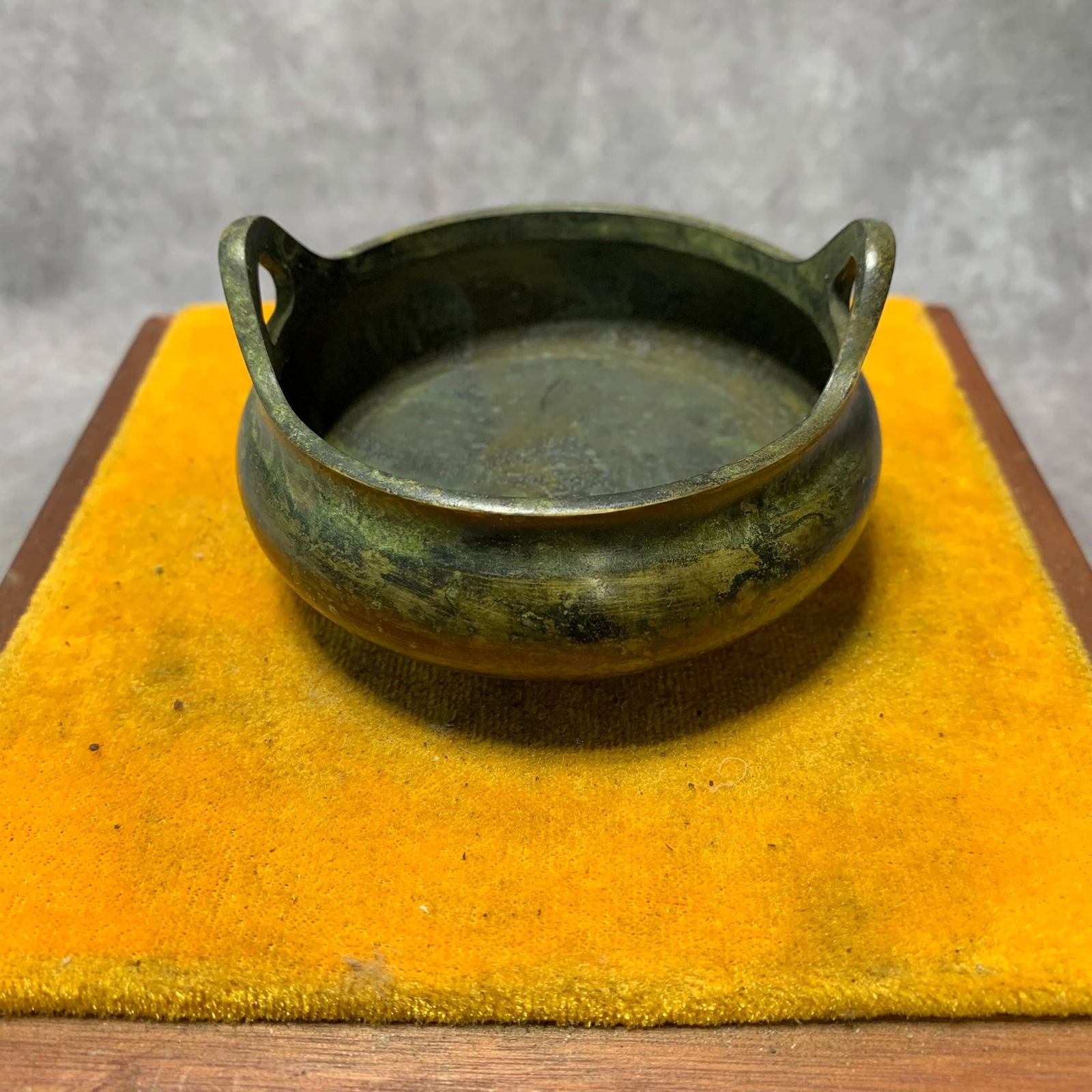 A FINE BRONZE THREE FOOT INCENSE BURNER WITH EAR HANDLES: Qing Dynasty; High: 2 inch; Diameter: 3.3 inch