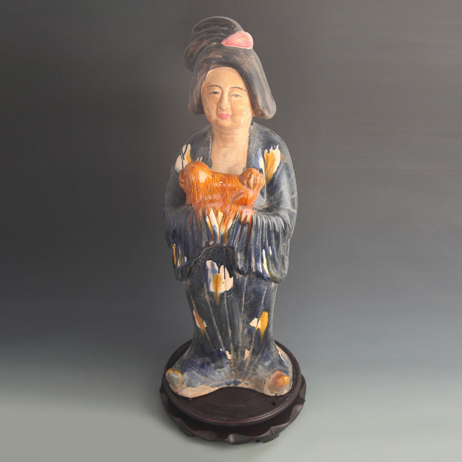 A LARGE POTTERY FEMALE FIGURINE HOLDING A DOG: Tang Dynasty Style; High: 25.0 inch; Width: 9.50 inch;