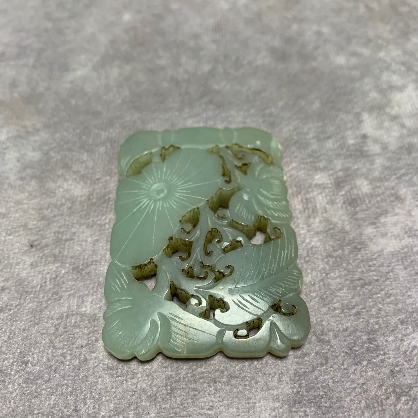 HETIAN GREENISH-WHITE JADE PLAQUE WITH LOTUS LEAF DESIGN: Qing Dynasty; Long: 2.6 inch; Width: 1.8 inch; High: 0.3 inch;