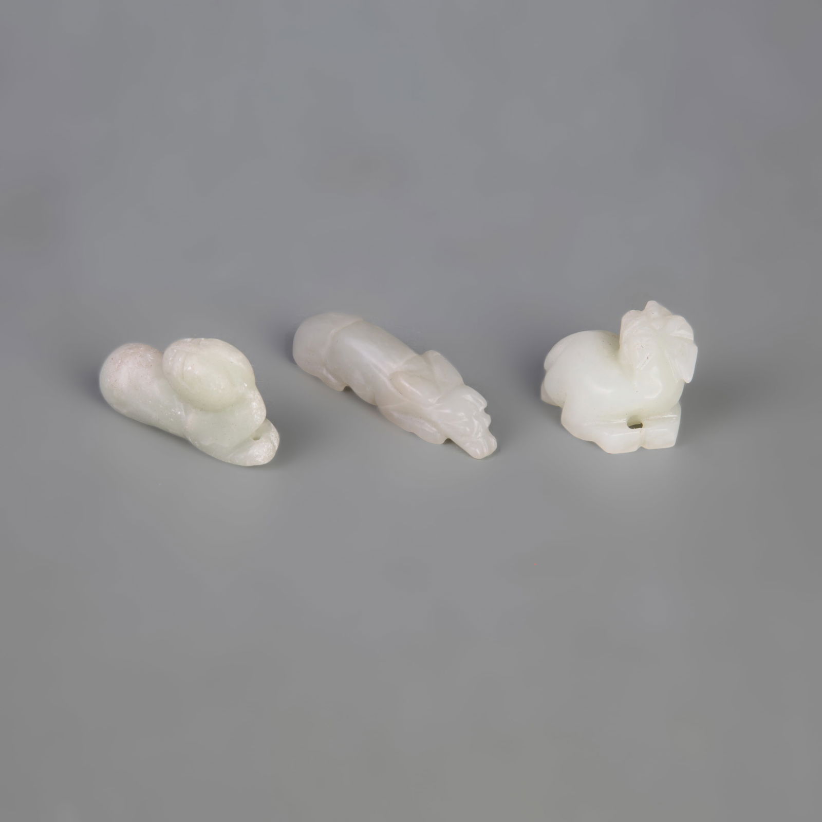 GROUP OF THREE HETIAN JADE PENDANTS: Qing Dynasty; Width: 0.5-1.0 inch; Long: 1.3-2.2 inch