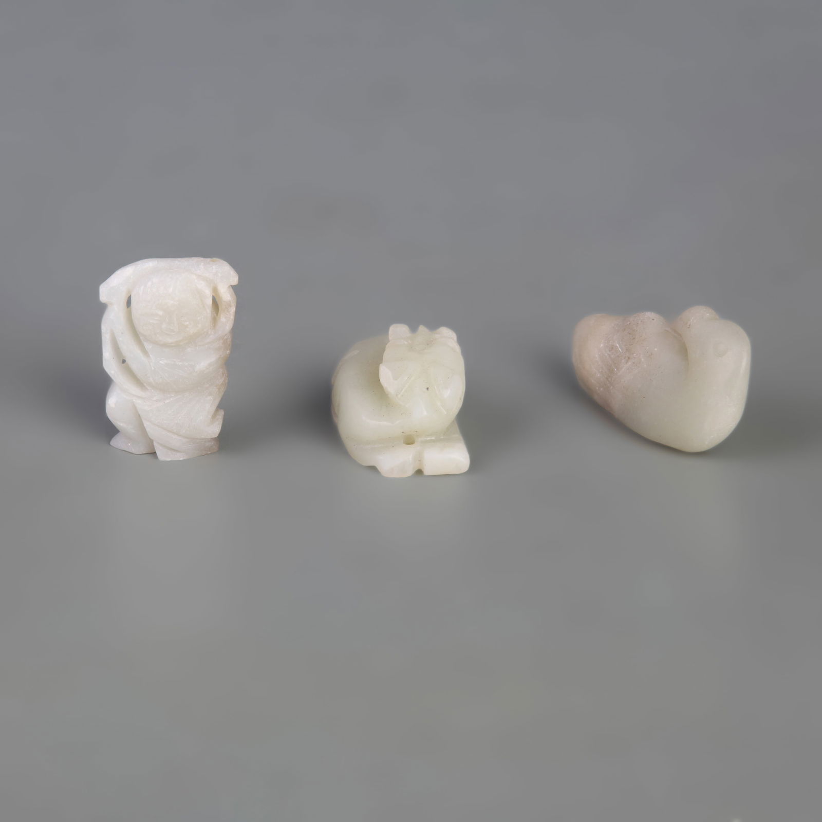 GROUP OF THREE HETIAN JADE PENDANTS: Qing Dynasty; Width: 0.8-1.0 inch; Long: 1.4-2.1 inch