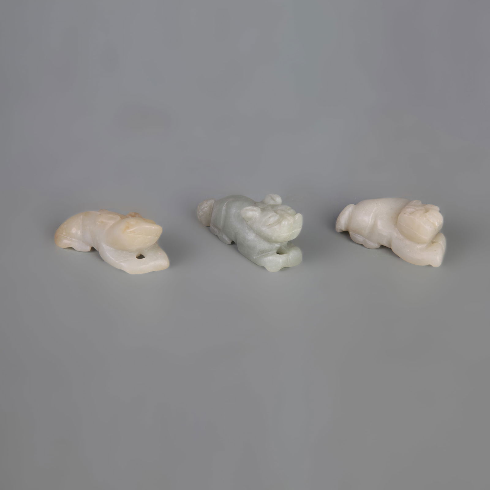 GROUP OF THREE HETIAN JADE PENDANTS: Qing Dynasty; Width: 0.6-0.8 inch; Long: 1.6-2.0 inch