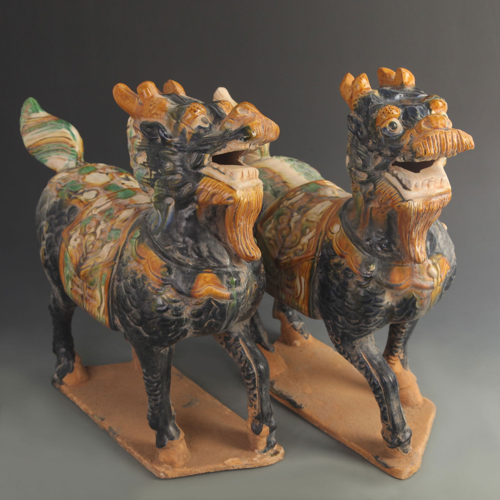 PAIR OF SANCAI GLAZED QI LIN FIGURE (WEALTH-BRINGING): Tang Dynasty Style; High: 15.5 inch; Width: 14.25 inch;