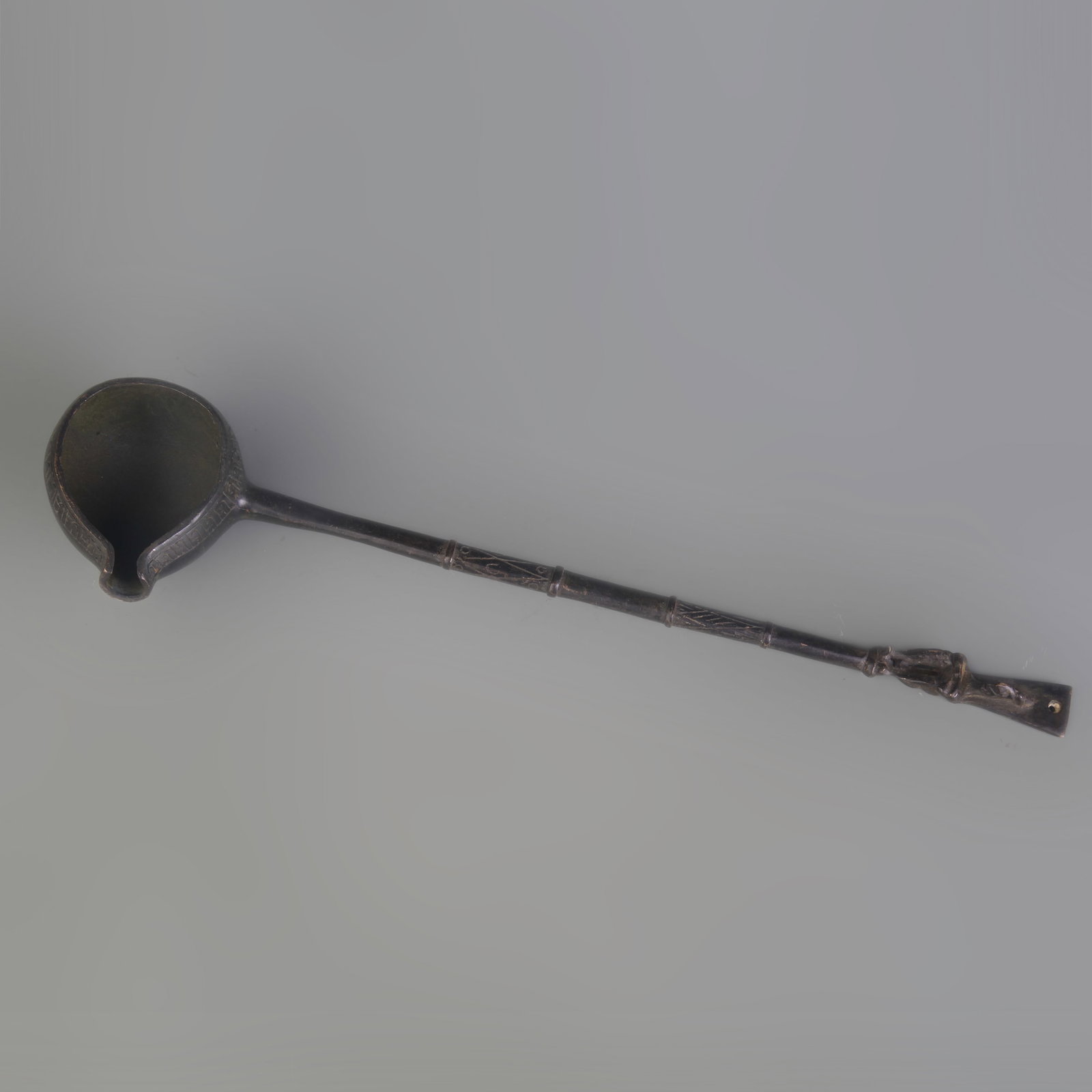 A LONG BRONZE MEASURING SPOON (1 of 4)