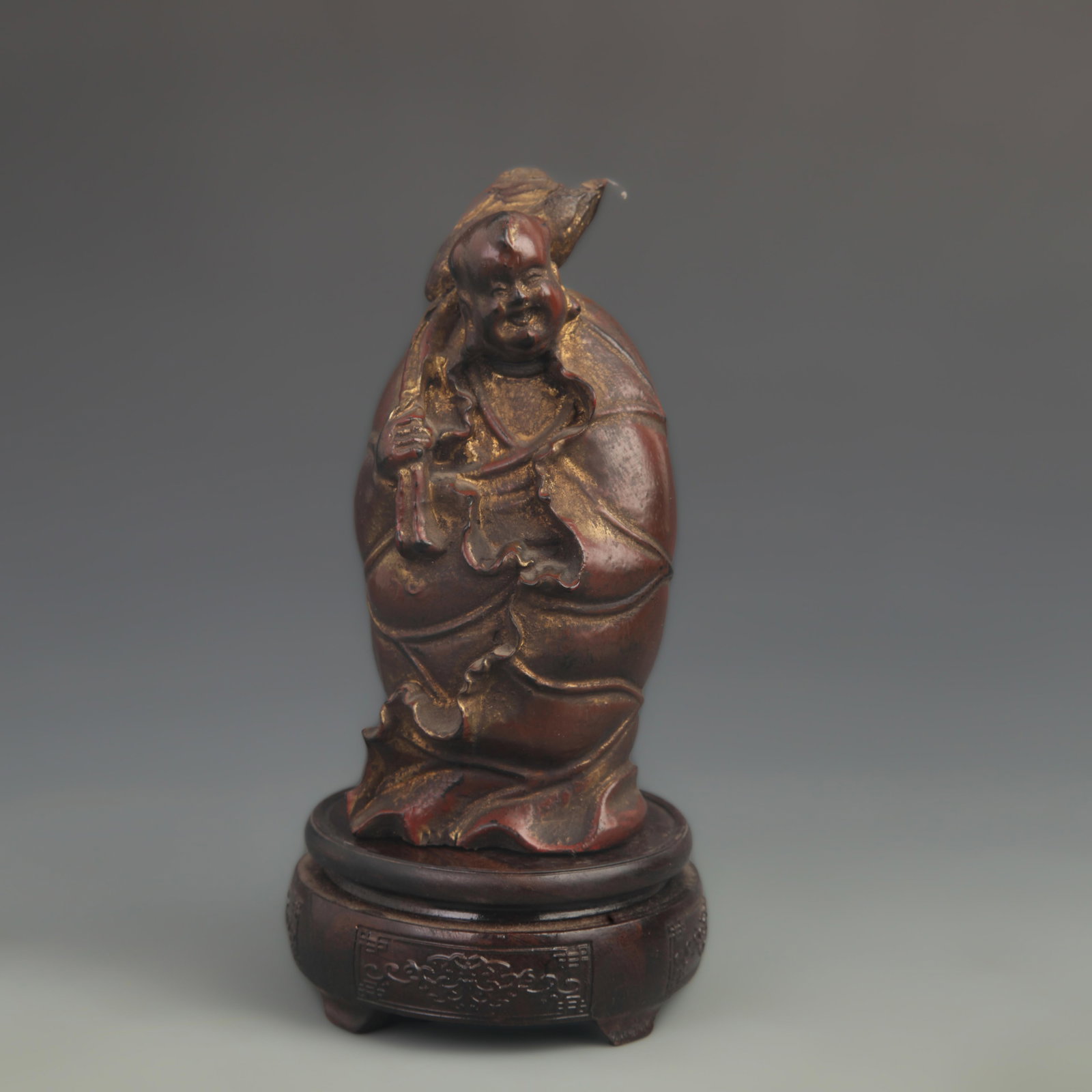 A FINE CARVED LACQUER AND LOTUS LEAF CHILD WOOD FIGURE: 20th Century; High: 7.25 inch; Width: 3.50 inch;