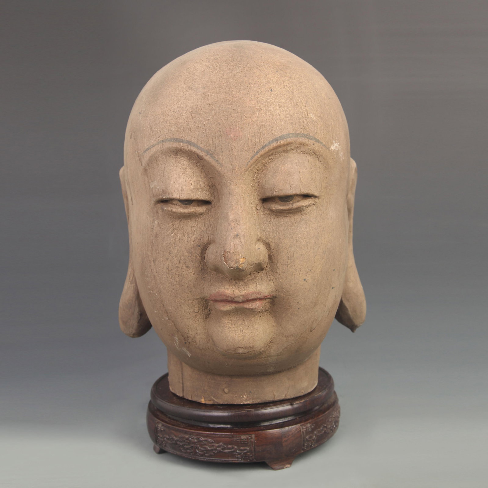 A WOODEN CARVED STATUE OF BODHISATTVA KSITIGARBHA'S HEAD: 18th Century; High: 11.25 inch; Width: 8.50 inch;