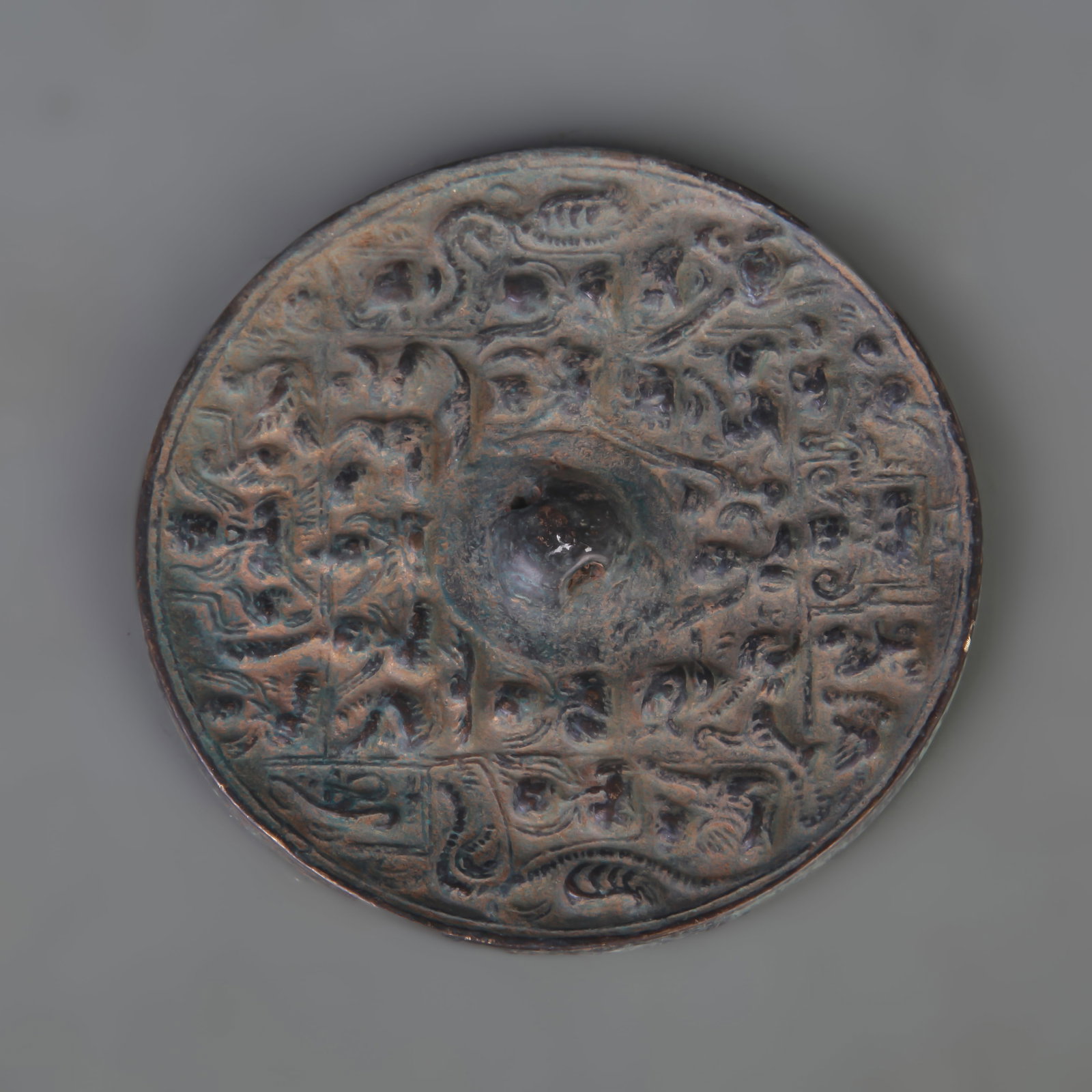 A BRONZE MIRROR CAST WITH AUSPICIOUS BEAST MOTIFS (1 of 4)