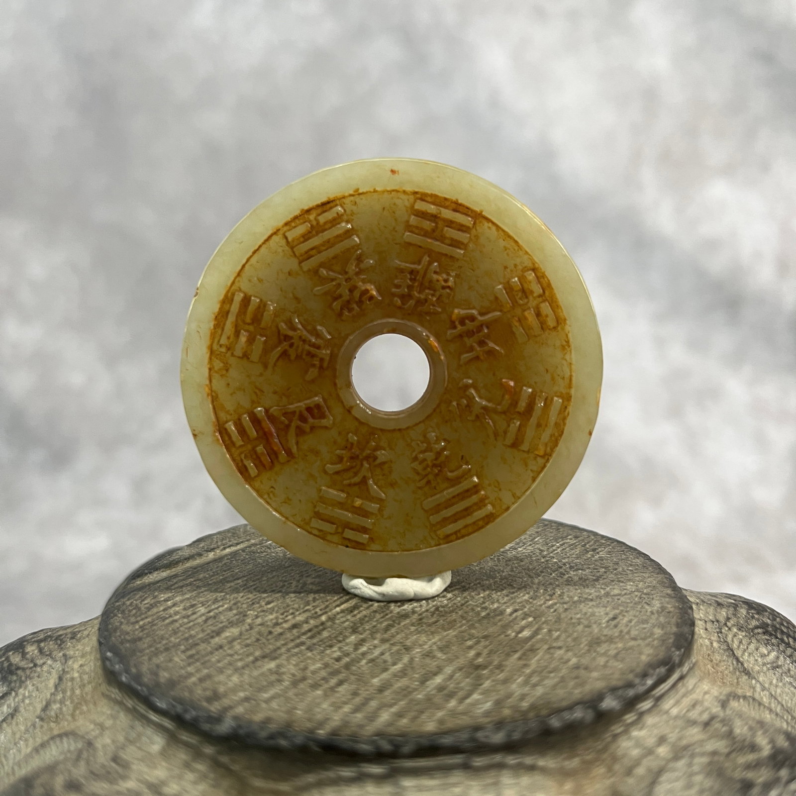 A FINE HETIAN JADE IN FIGURE OF CHINESE BI DISC: Qing Dynasty; High: 0.22 inch; Diameter: 2.3 inch;