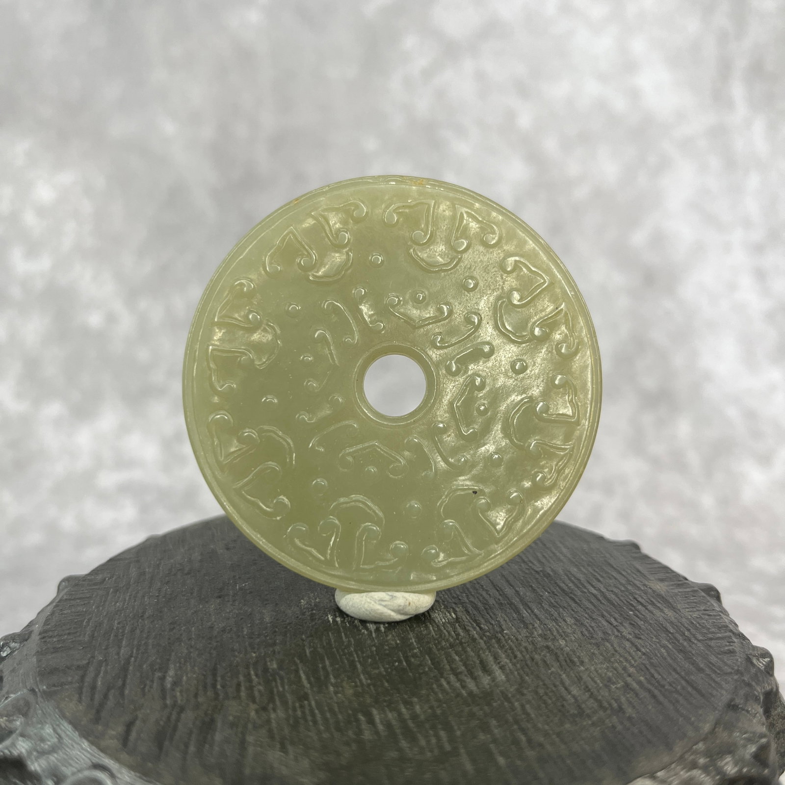 A FINE HETIAN JADE IN FIGURE OF CHINESE BI DISC: Qing Dynasty; Long: High: 0.21 inch; Diameter: 2.3 inch;