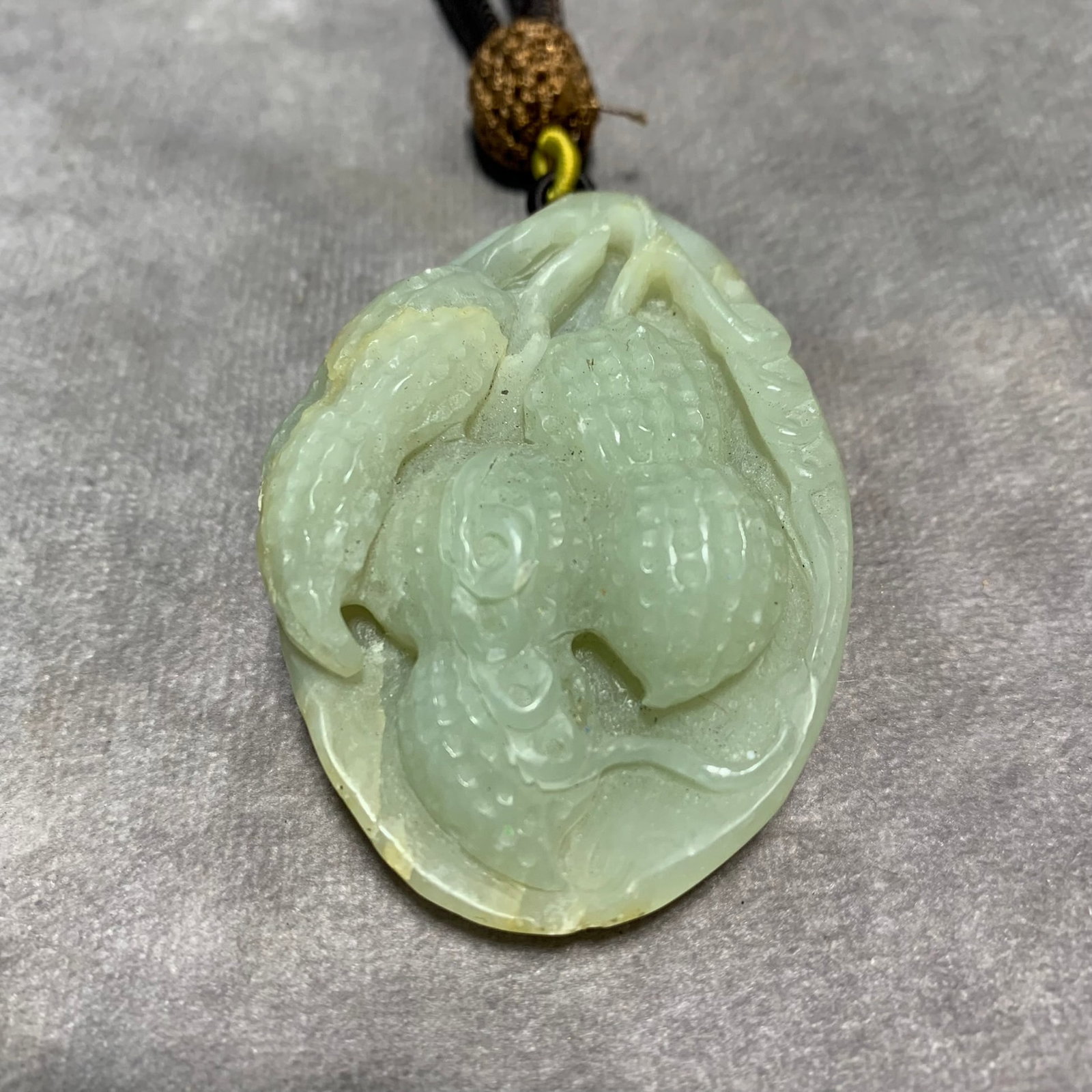 HETIAN CELADON-WHITE JADE PENDANT OF CARVED PEANUT: Qing Dynasty; Long: 2.5 inch; Width: 1.7 inch; High: 0.8 inch;