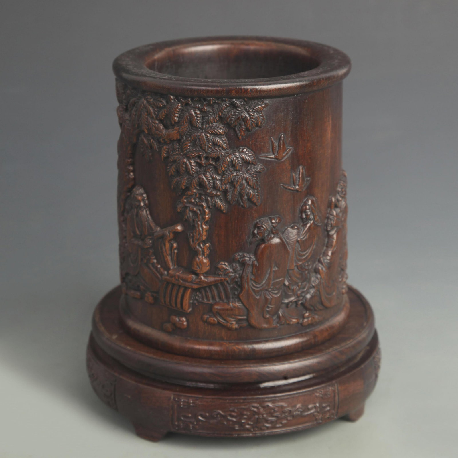 AN EBONY BRUSH POT CARVED WITH A SCENE OF CONFUCIUS TEACHING: 19th Century ; High: 5.75 inch; Diameter: 5.00 inch;