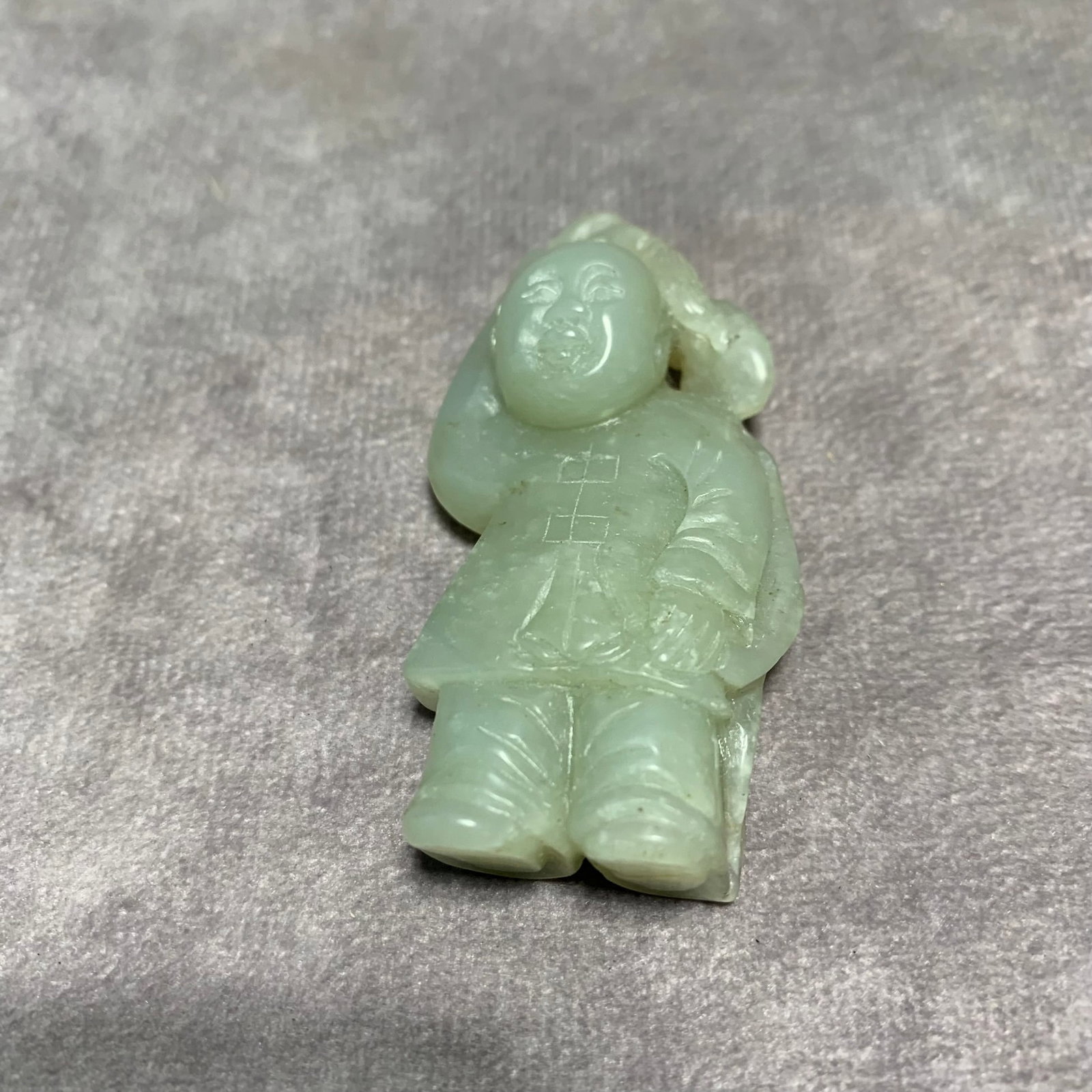A FINE HETIAN PALE CELADON JADE IN FIGURE OF A BOY: Qing Dynasty; Long: 2.4 inch; Width: 1.2 inch; High: 0.6 inch;