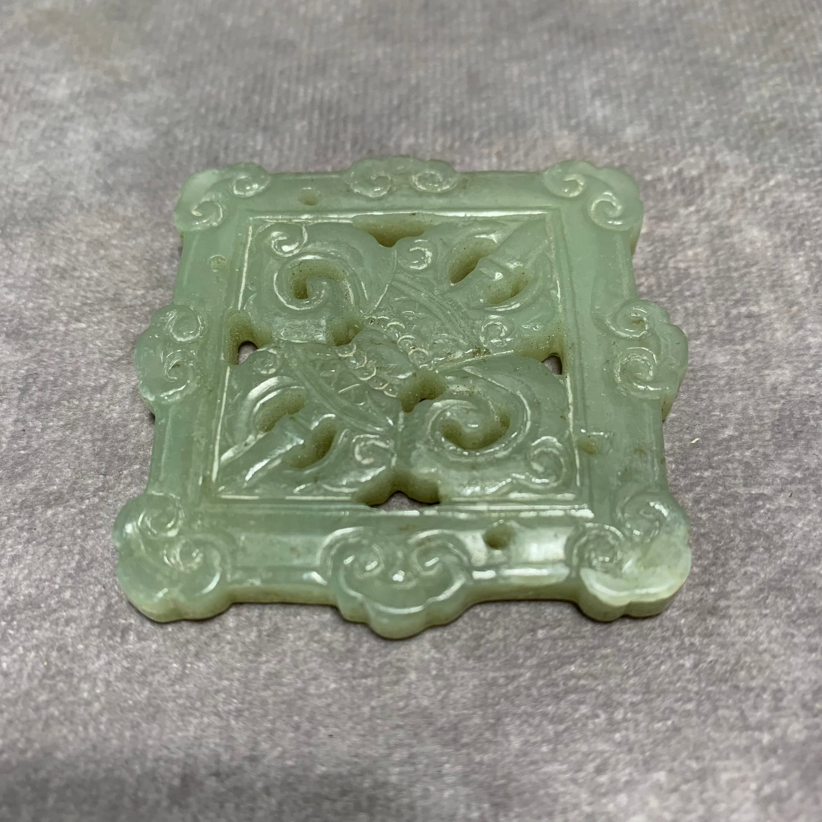 HETIAN CELADON-WHITE JADE PENDANT WITH VAJRA PATTERNS: Qing Dynasty; Long: 2.1 inch; Width: 2 inch; High: 0.2 inch;