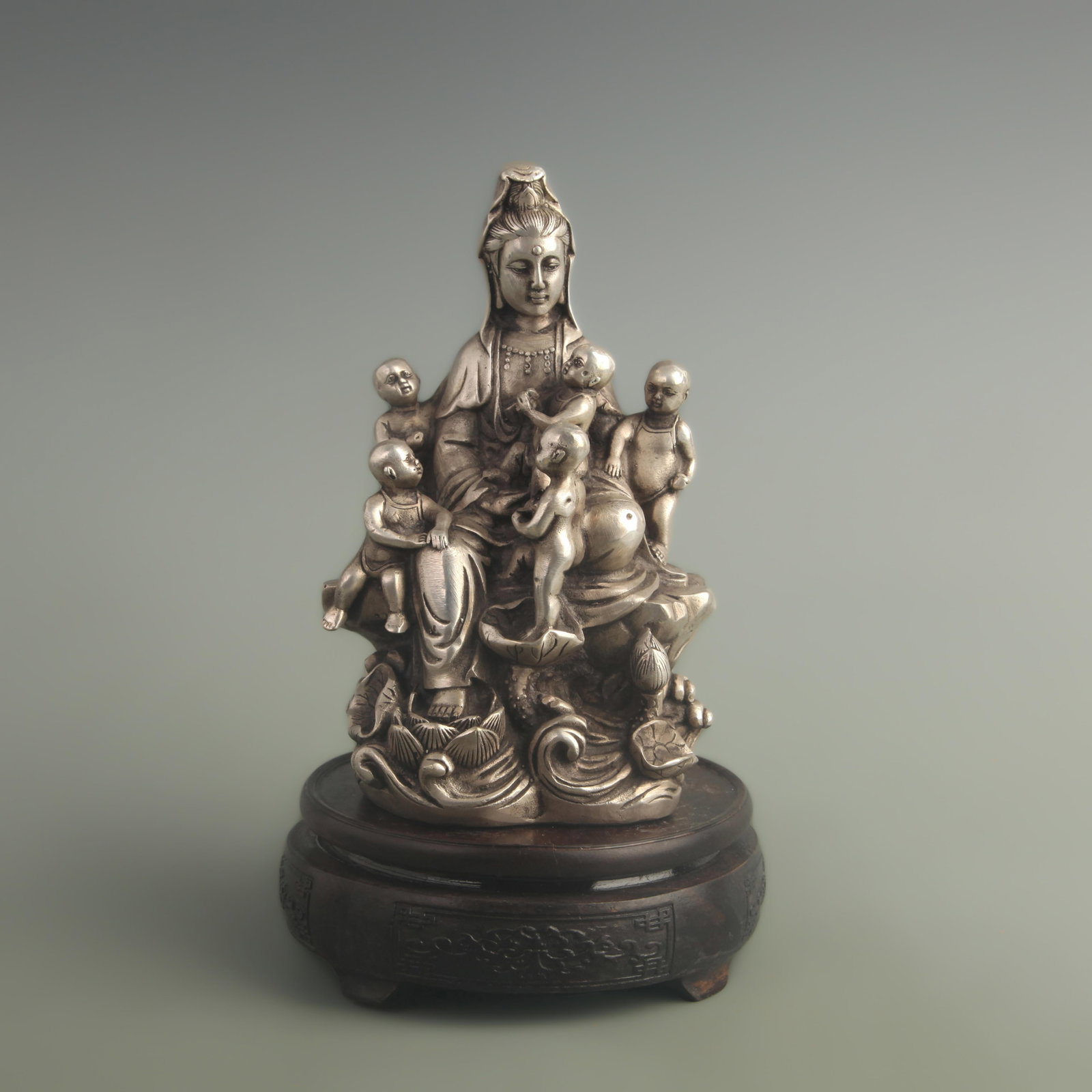A SILVERED BRONZE FIGURE OF CHILD-GIVING GUANYIN: Qing Dynasty Qian Long Period; High: 7.00 inch; Width: 3.20 inch; Long: 3.90 inch
