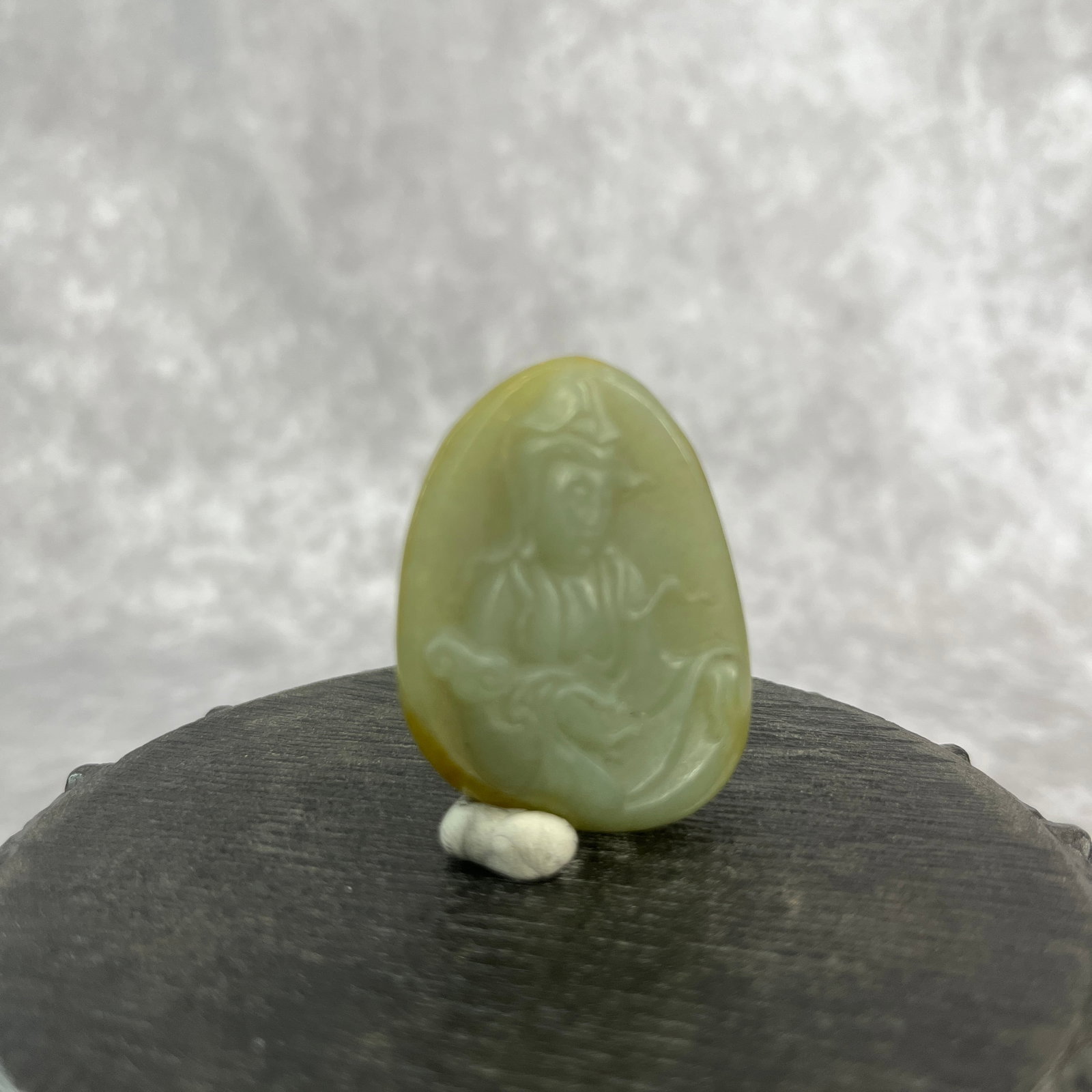 A FINE HETIAN JADE IN FIGURE OF GUAN YIN: Qing Dynasty; Long: 1.7 inch; Width: 1.28 inch; High: 0.39 inch;