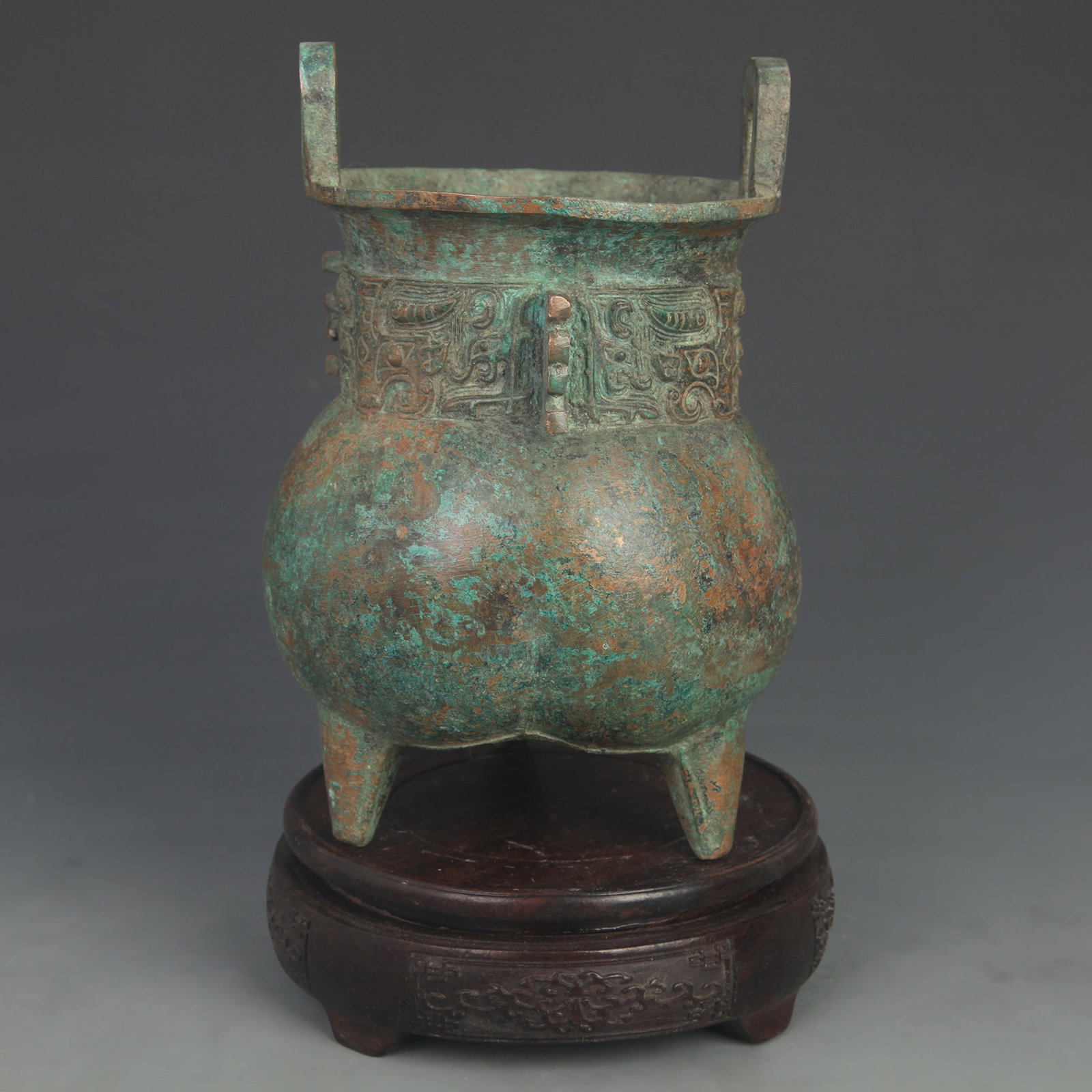 AN ARCHAISTIC BRONZE DING TRIPOD WITH TAOTIE AND INSCRIPTION MOTIFS (1 of 5)