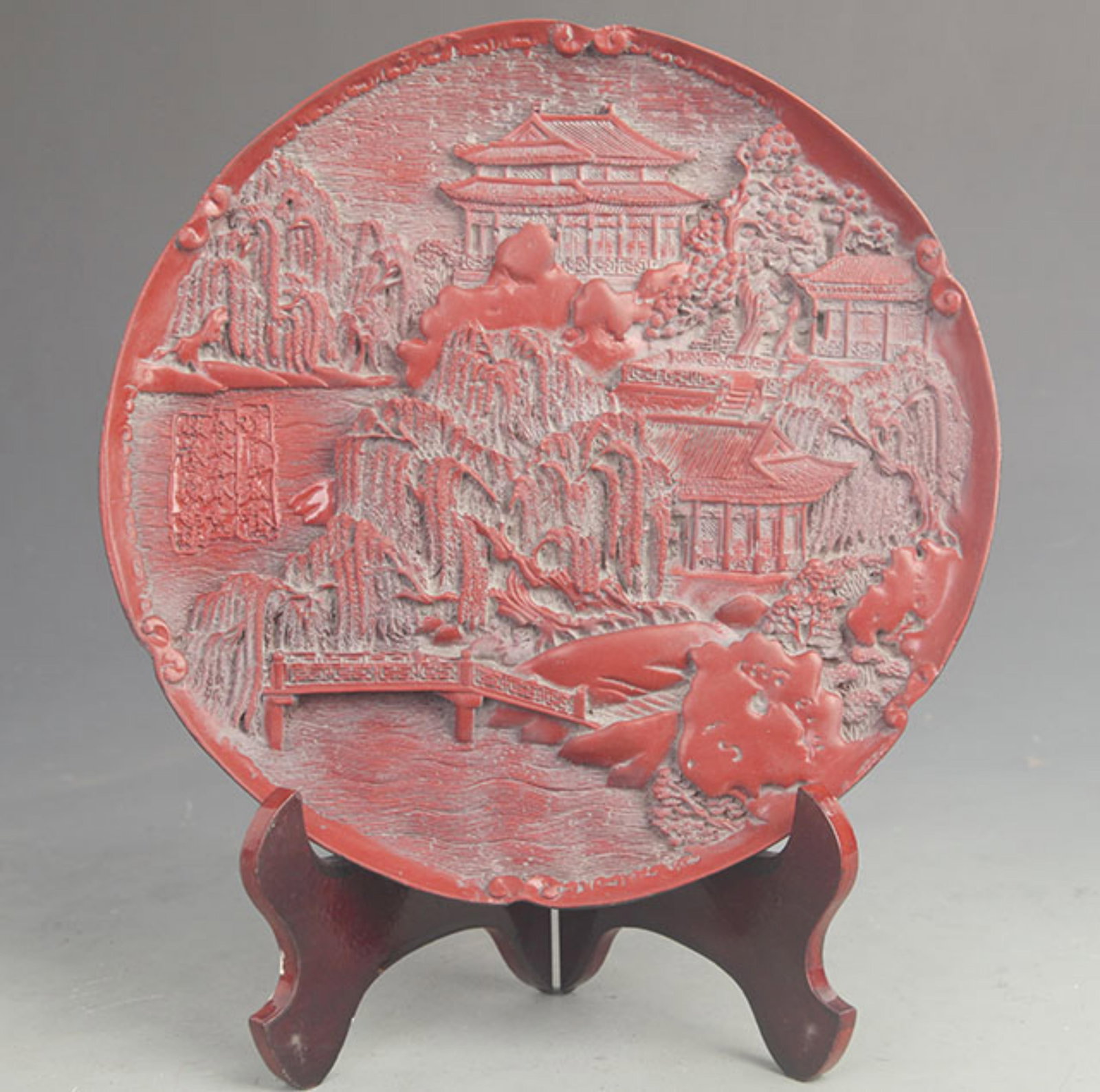 CARVED RED LACQUER PLATE CARVING WITH HOUSE AND BACKYARD: Qing Dynasty; High: 0.75 inch; Diameter: 9.50 inch;