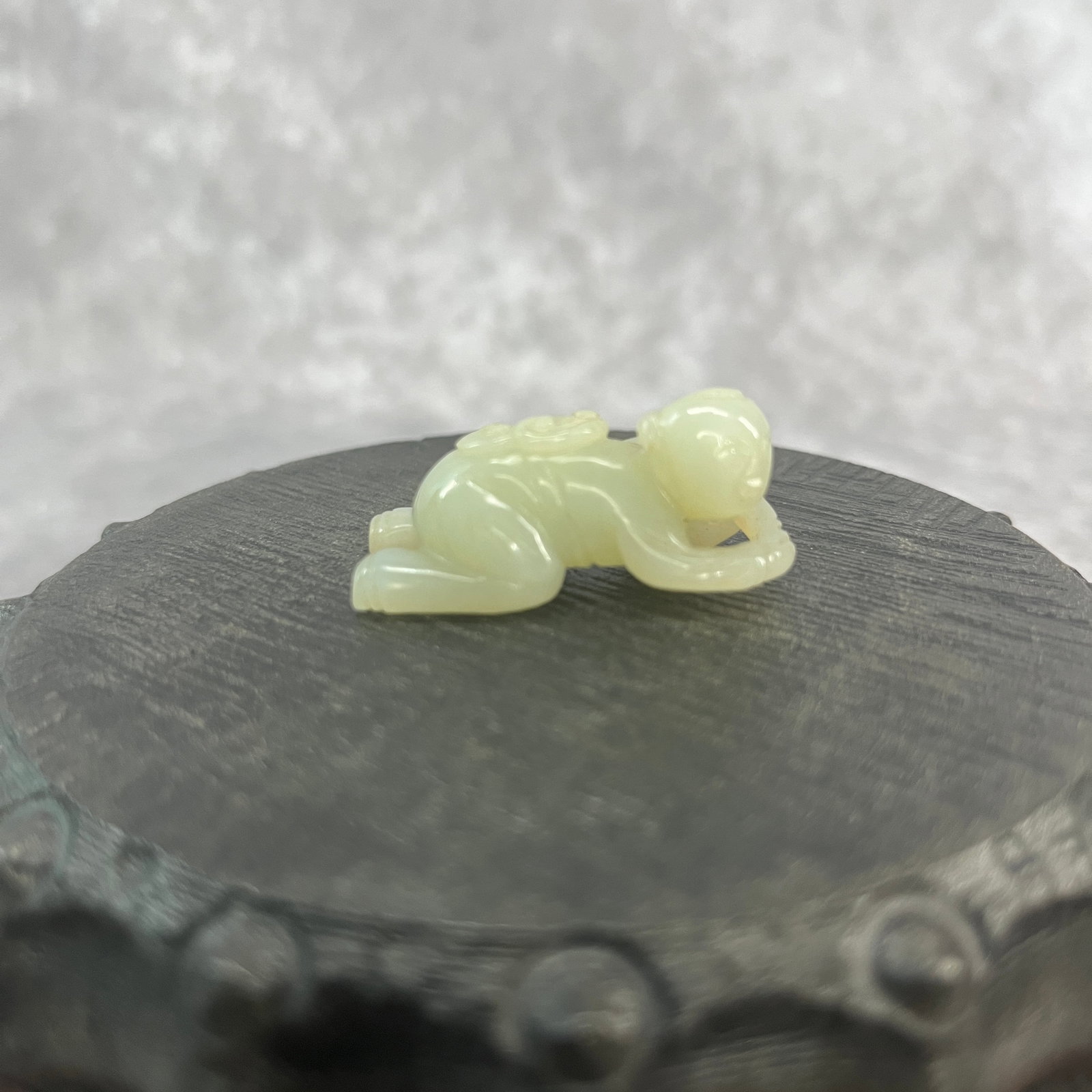A FINE HETIAN CELADON JADE IN FIGURE OF PLAYING BOY: Qing Dynasty; Long: 1.5 inch; Width: 0.7 inch; High: 0.61 inch;