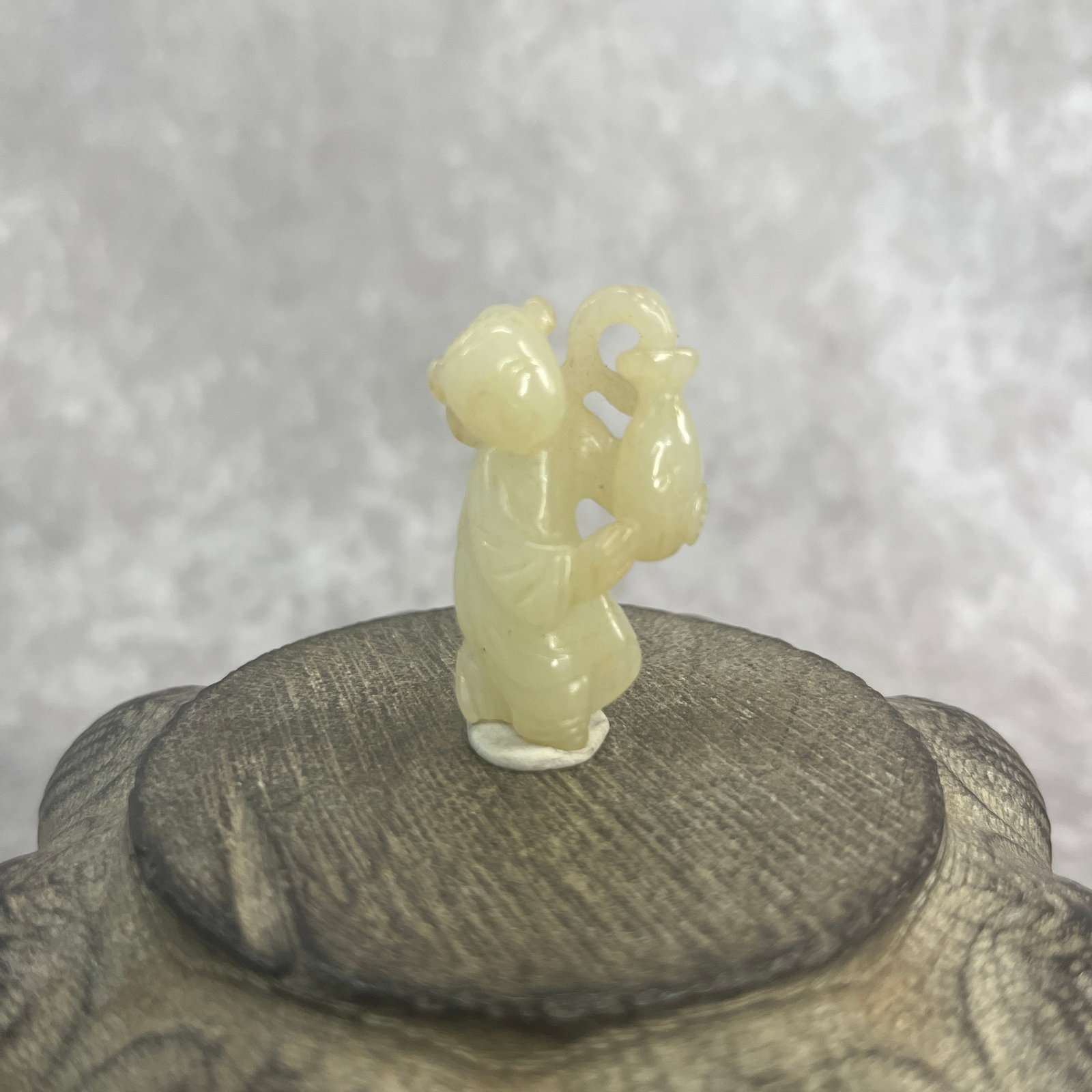 A FINE HETIAN CELADON JADE IN FIGURE OF PLAYING BOY: Long: 1.6 inch; Width: 0.91 inch; High: 0.53 inch;