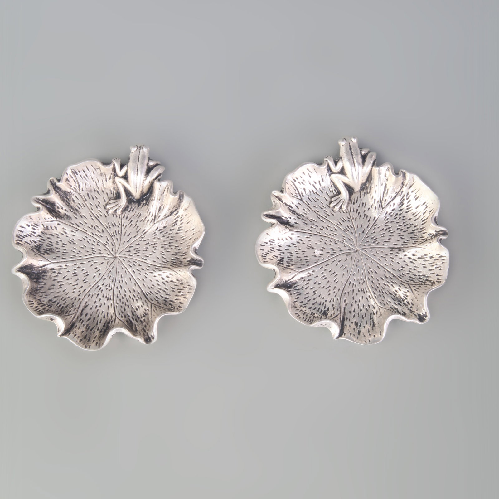 PAIR OF SILVER-PLATED LOTUS AND FROG PATTERN PLATES: Republic Period; Long: 4.0 inch