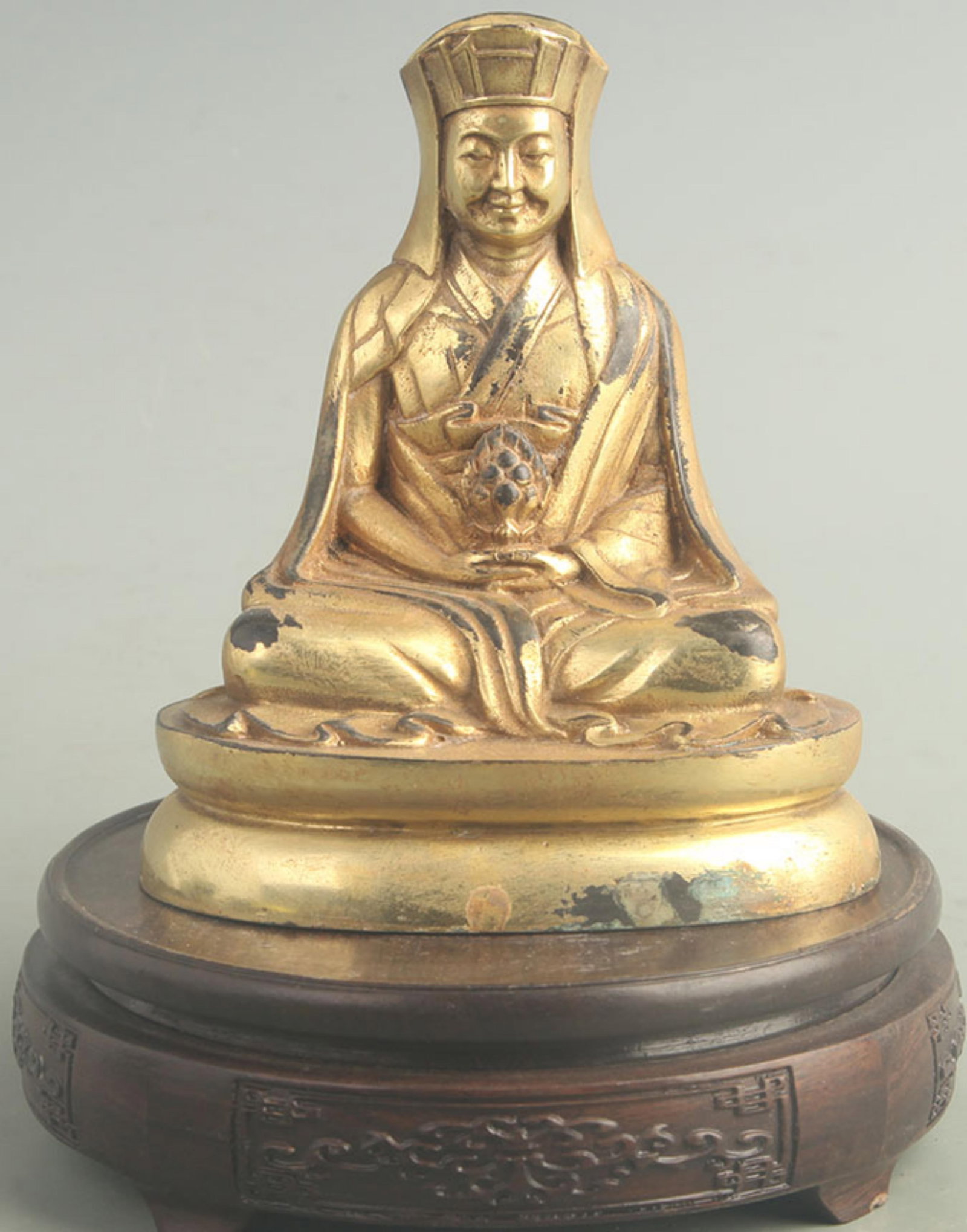 GILT-BRONZE TIBETAN BUDDHIST SEATED ARHAT: 20th Century; High: 5.80 inch; Width: 3.20 inch; Long: 5.00 inch; Woodbase for picture and display only