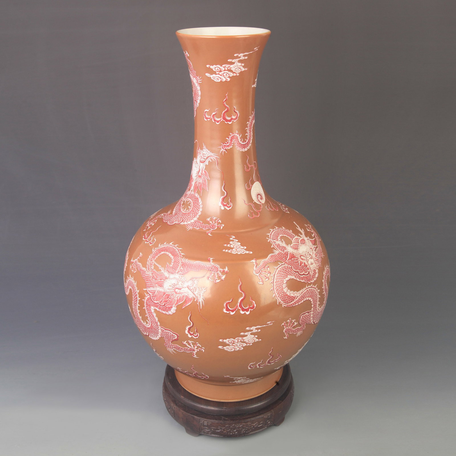 A RED COLOR GLAZED DRAGON PATTERN PORCELAIN BOTTLE: Qing Dynasty Kangxi Period, High: 16.3 inch; Diameter: 9.00 inch; Woodbase for picture and display only