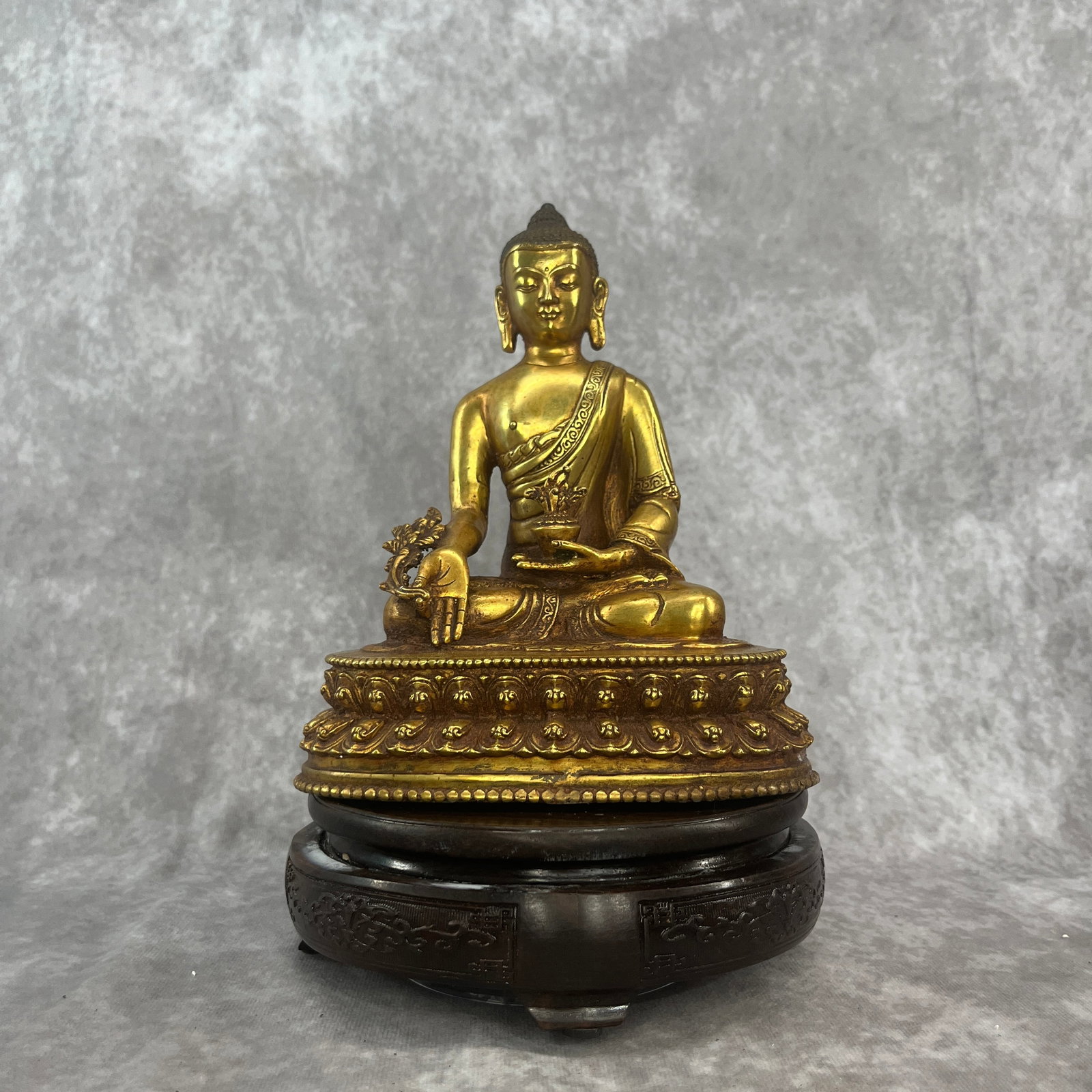 A FINE GILT BRONZE MEDICINE BUDDHA STATUE: Qing Dynasty; Long: 6.4 inch; Width:4.4 inch; Heigh: 7.9 inch; Woodbase for picture and display only