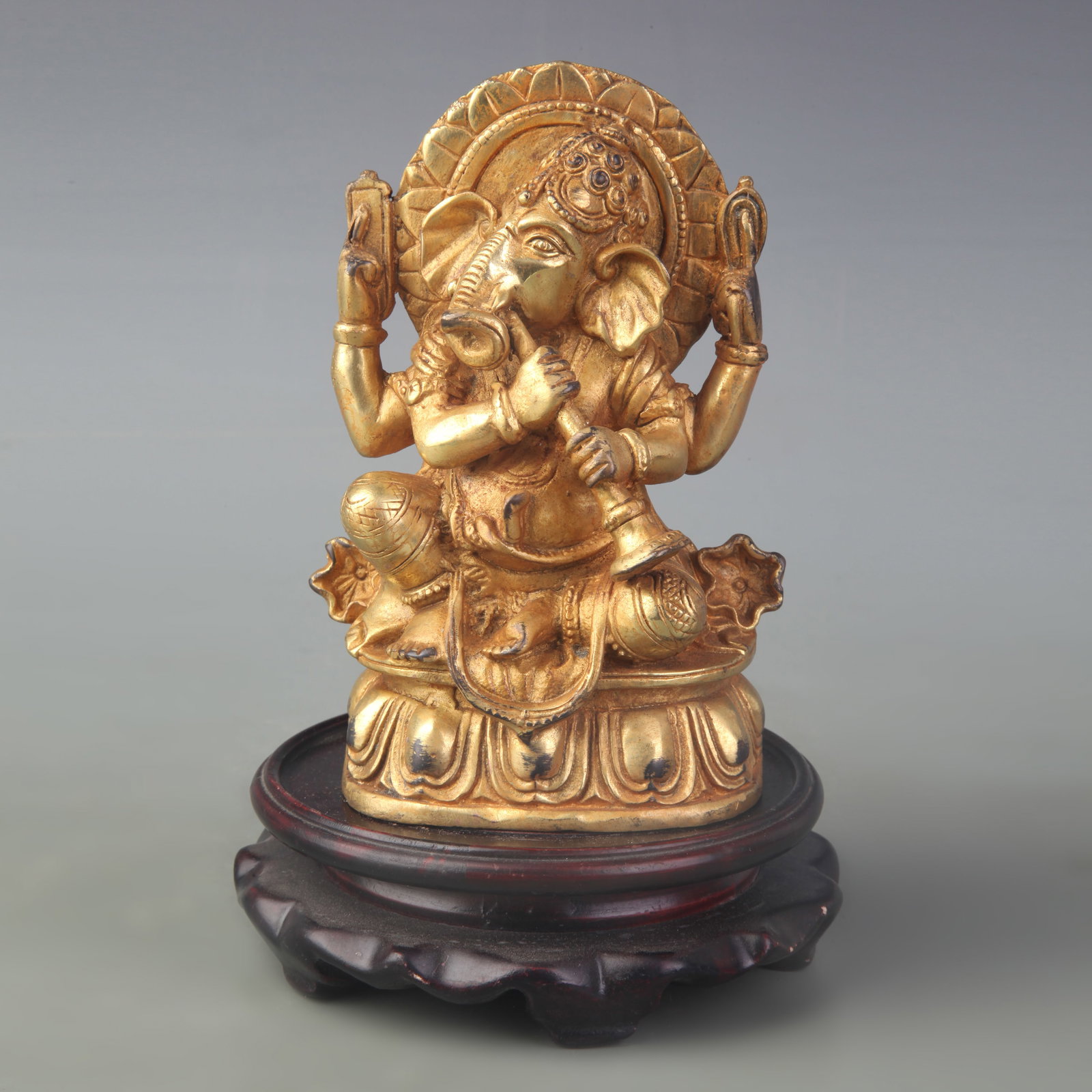 A FINE GILT BRONZE TIBETAN STATUE OF GANESHA, LORD OF OBSTACLES: Qing Dynasty; High: 6.0 inch; Woodbase for picture and display only