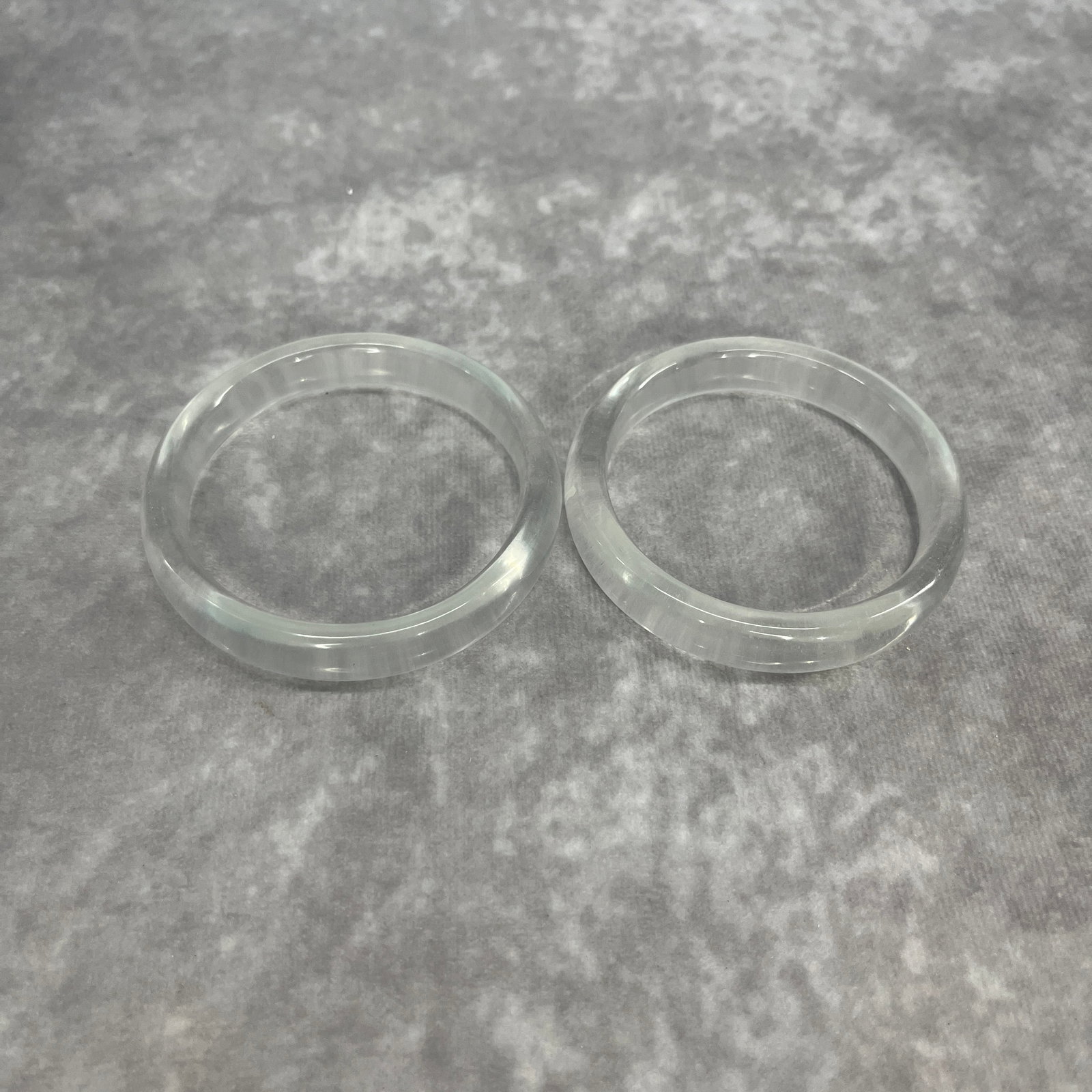 PAIR OF CRYSTAL MADE BRANGLE: Modern; Diameter: 2.42 inch; Diameter: 2.29 inch; Woodbase for picture and display only