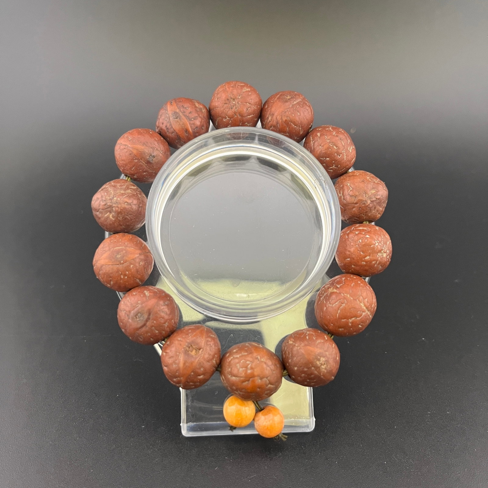 A FINE LONGAN SEED BRACELET: Modern; Long: 4.3 inch; Diameter: 0.6 inch; Woodbase for picture and display only