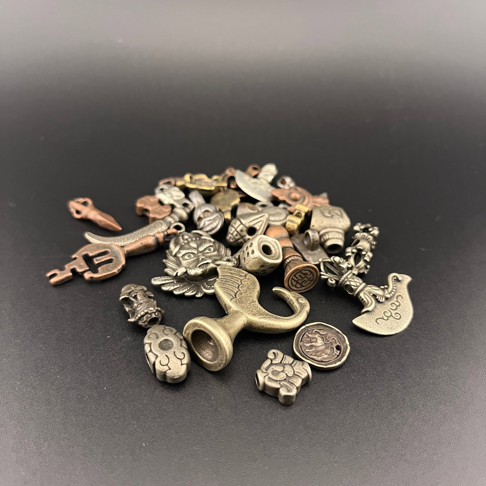 GROUP OF SMALL TIBETAN BUDDHIST PENDANT: Modern; Long: 0.52 inch to 1.3 inch; Width:0.32 inch to 1.18 inch; Heigh: 0.17 inch to 0.5 inch; Woodbase for picture and display only