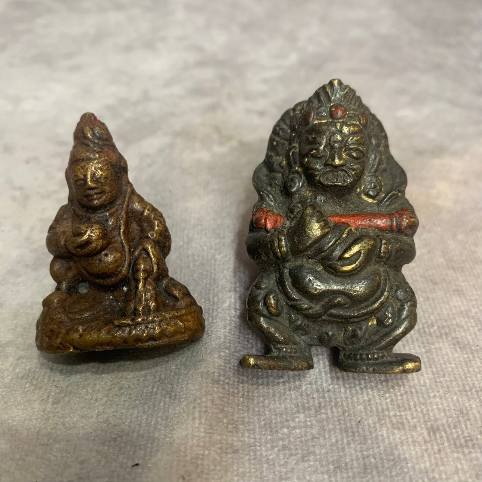 PAIR OF BRONZE TIBETAN BUDDHA PENDANT: 20th Century; High: 2.3 inch; Width: 1.4 inch. High: 1.9 inch; Width: 1.3 inch; Woodbase for picture and display only