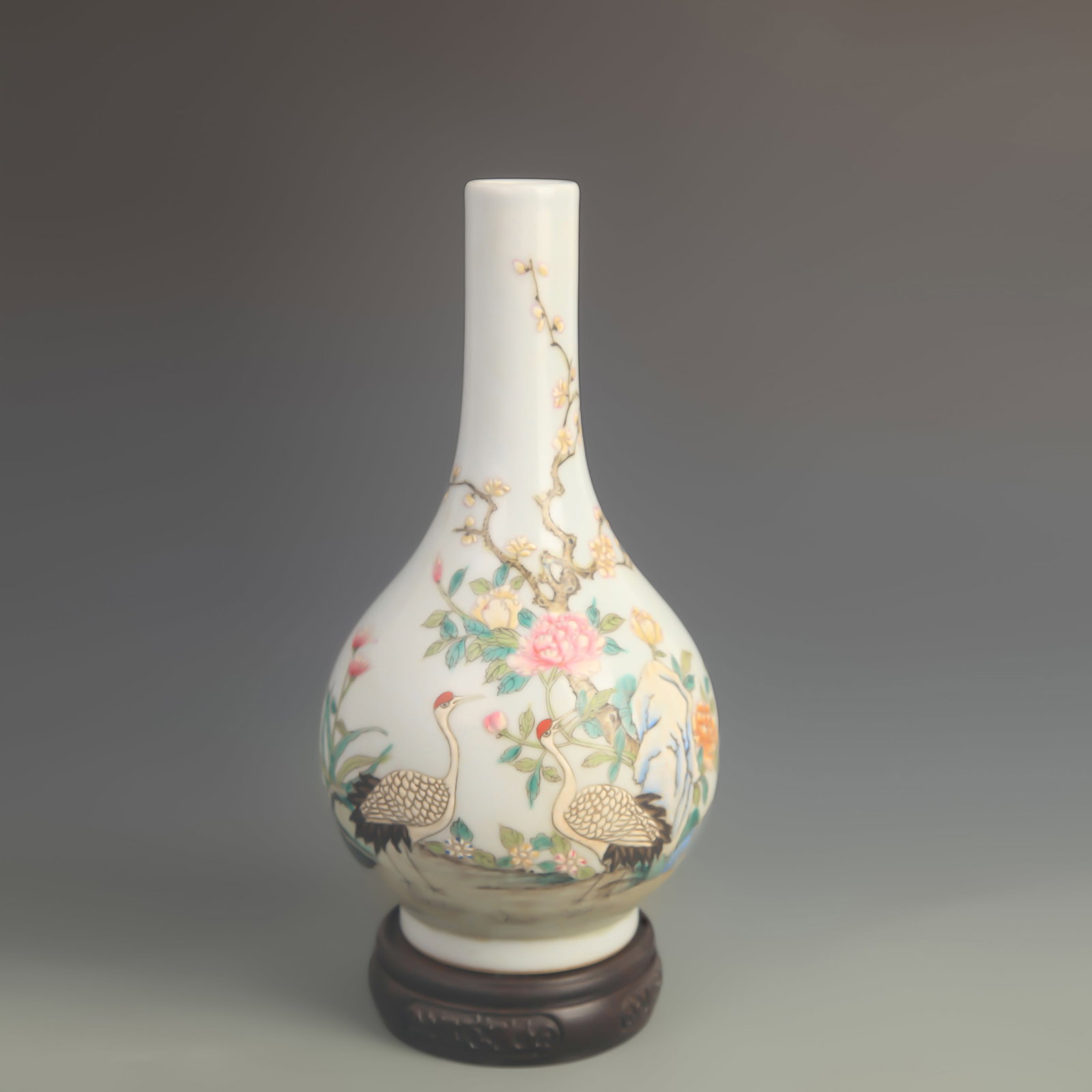 AN ENAMEL-PAINTED LONG-NECK VASE WITH FLORAL AND BIRD DECORATION: Qing Dynasty Qian Long Period; High: 9.80 inch; Diameter: 5.00 inch; Woodbase for picture and display only