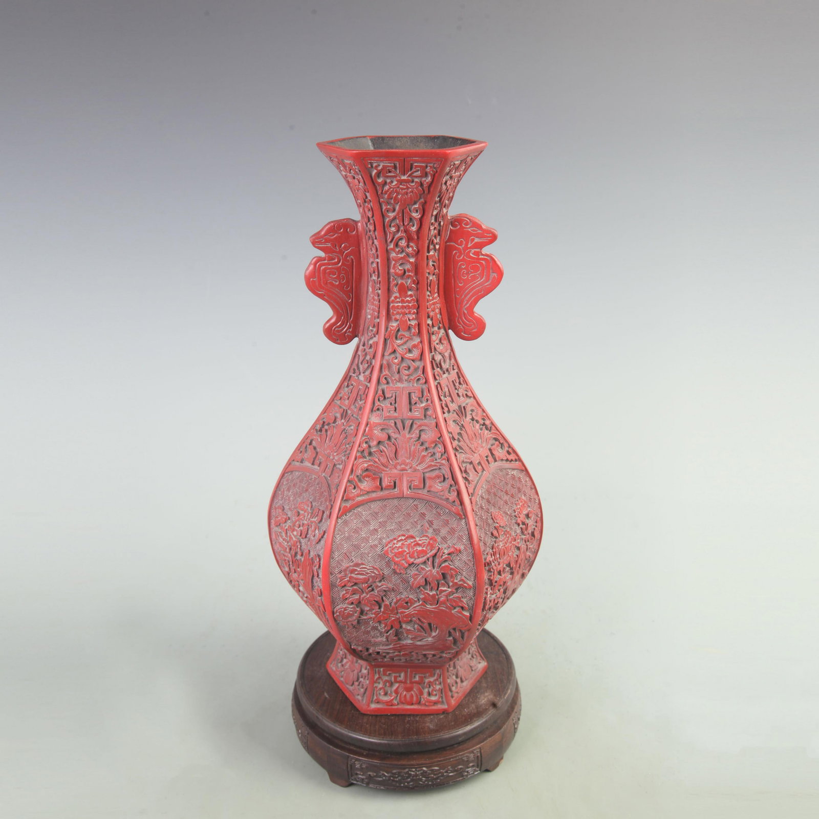 A CARVED CINNABAR LACQUER HEXAGONAL VASE WITH FLORAL PANELS: Qing Dynasty; High: 14.8 inch; Width: 7 inch; Long: 7 inch; Woodbase for picture and display only