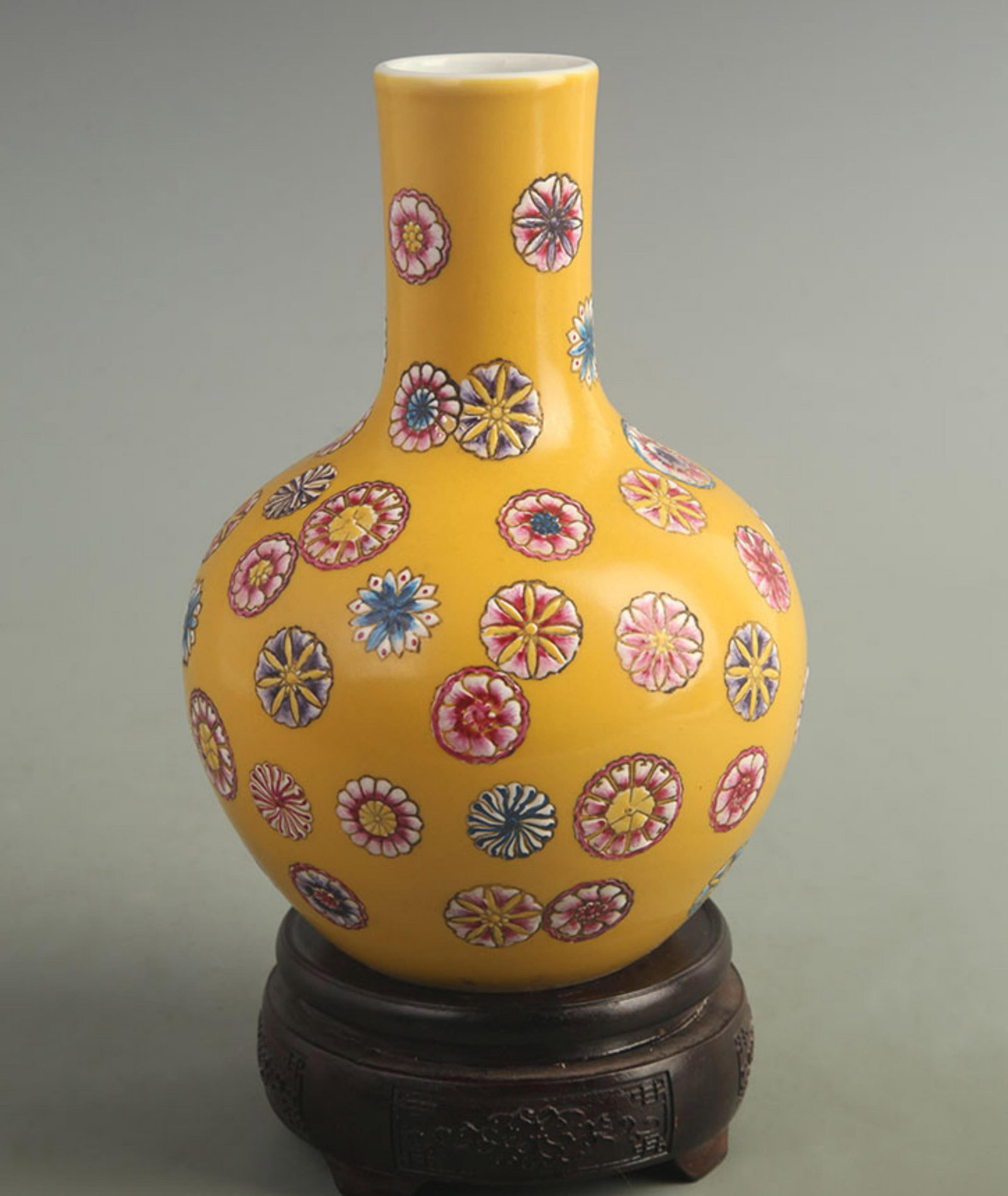 FAMILLE ROSE YELLOW GROUND FLORAL CELESTIAL SPHERE VASE: Qing Dynasty Qian Long Period; High: 8.20 inch; Width: 5.50 inch; Woodbase for picture and display only
