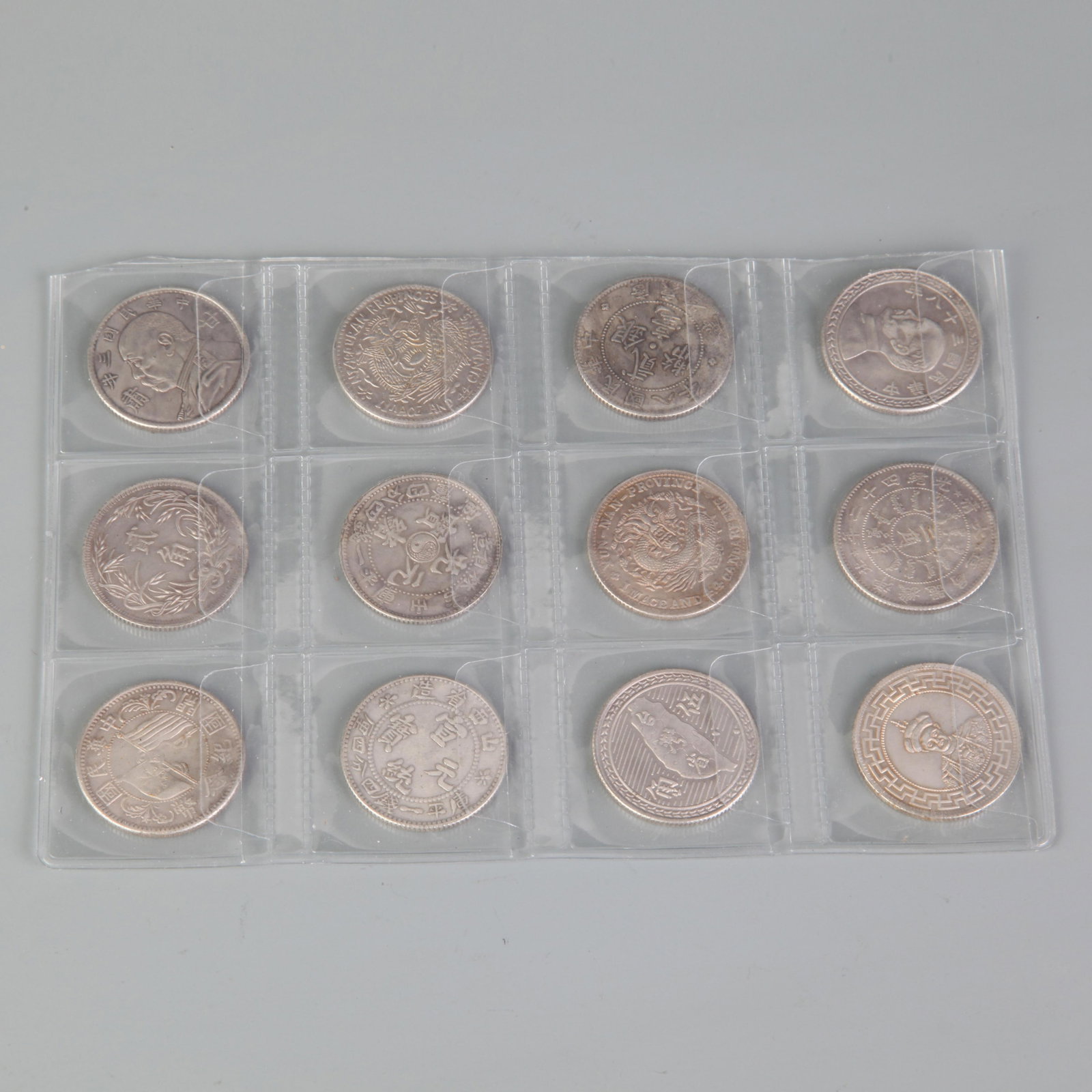A FINE VINTAGE TWELVE CHINESE COIN COLLECTION: Republic Period; Diameter: 1.0 inch; Woodbase for picture and display only