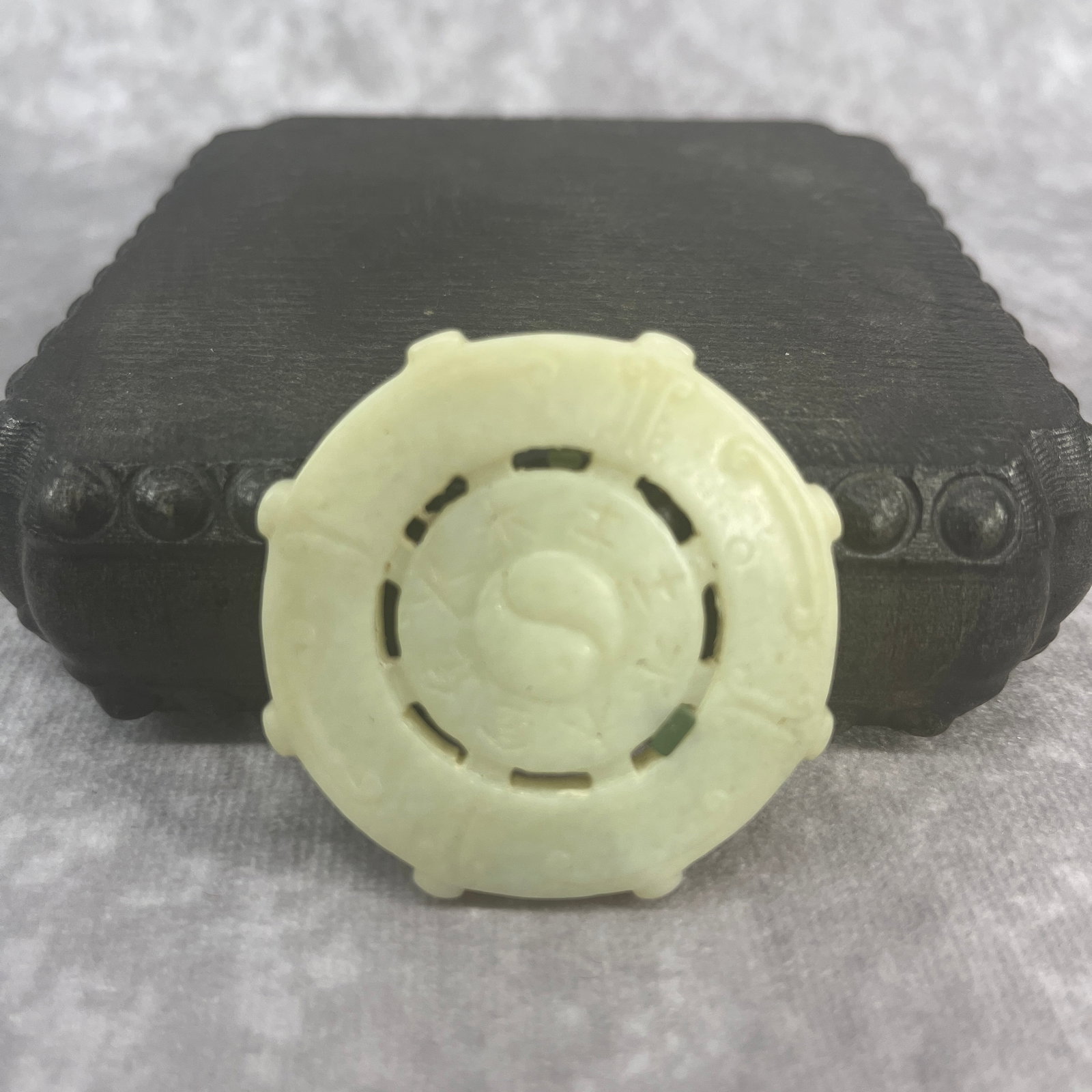 A FINE HETIAN BAGUA AND TAIJI JADE PLAQUE: Qing Dynasty; Heigh: 0.2 inch; Diameter: 2.02 inch; Woodbase for picture and display only
