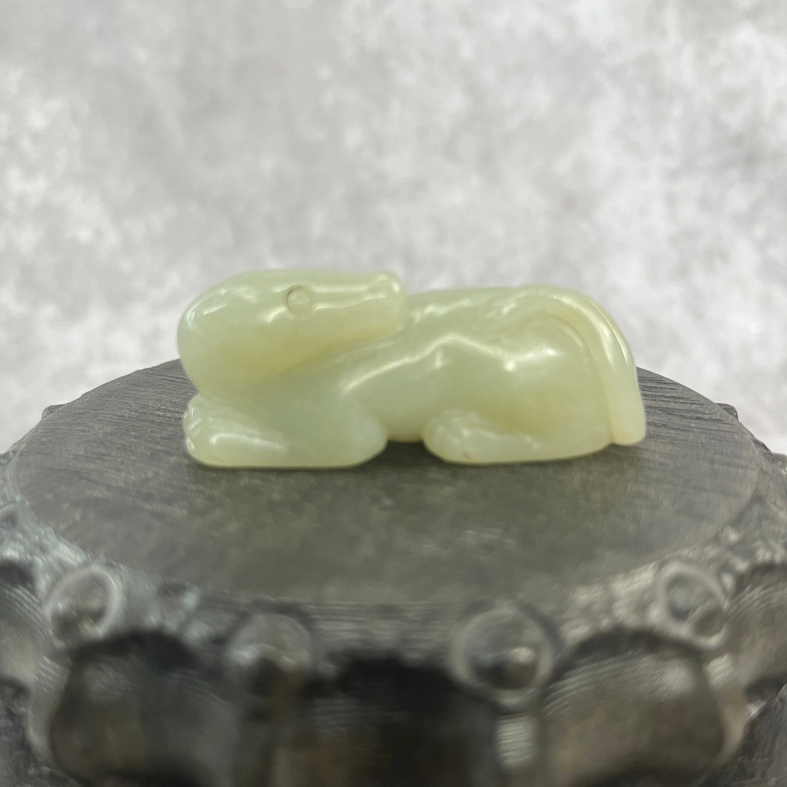 A FINE HETIAN JADE IN FIGURE OF DOG: Qing Dynasty; Long: 2.24 inch; Width:0.93 inch; Heigh: 0.88 inch; Woodbase for picture and display only