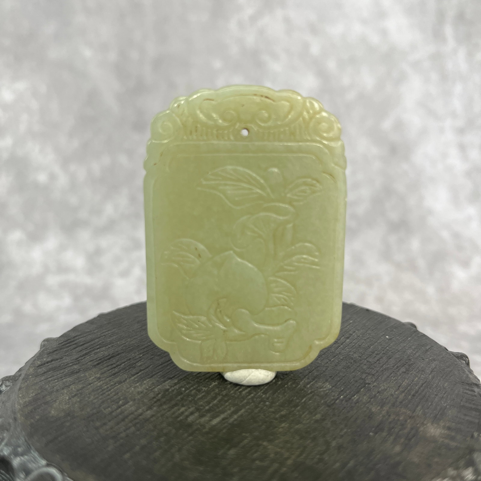 A FINE HETIAN JADE PENDANT IN FIGURE OF PEACH: Qing Dynasty; Long: 2.21 inch; Width: 1.52 inch; High: 0.22 inch; Woodbase for picture and display only