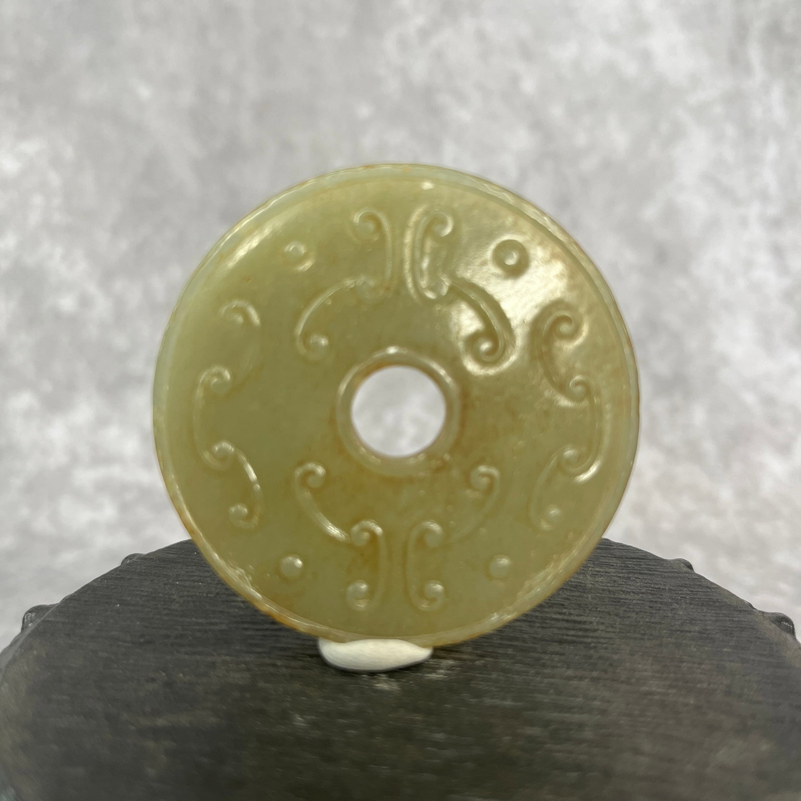 A FINE HETIAN JADE BI DISC PENDANT IN FIGURE OF BEAST PATTER: Qing Dynasty; High: 0.23 inch; Diameter: 2.2 inch; Woodbase for picture and display only