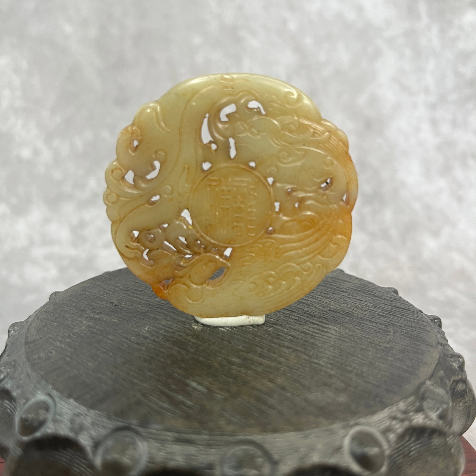 A FINE HAND CARVED HETIAN JADE PENDANT WITH PHOENIXES PATTER: Qing Dynasty; High: 0.2 inch; Diameter: 2.16 inch; Woodbase for picture and display only