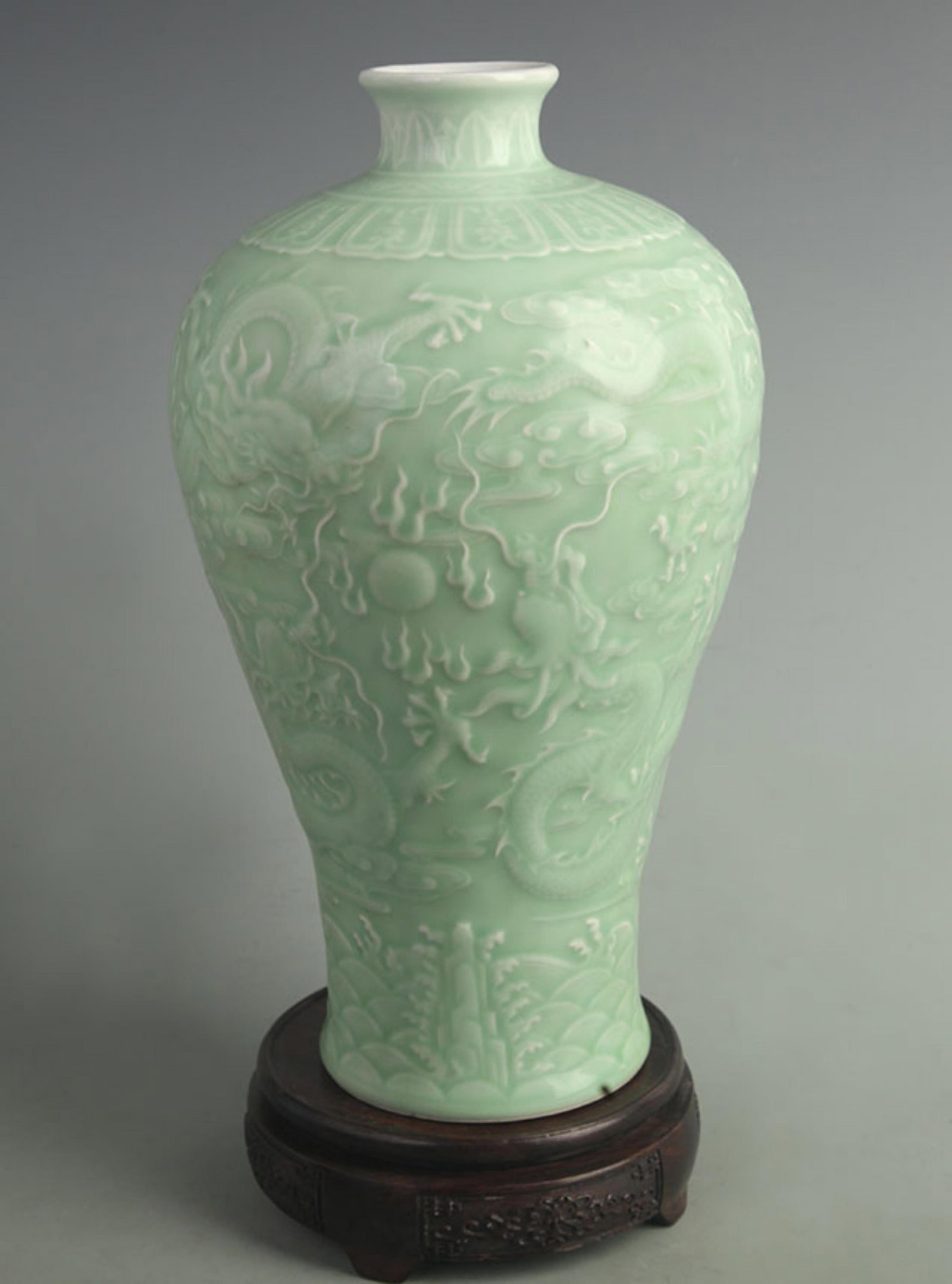 A CELADON-GLAZED CARVED DRAGON PLUM VASE: Qing Dynasty Qian Long Period; High: 11.2 inch; Diameter: 4.00 inch; Woodbase for picture and display only