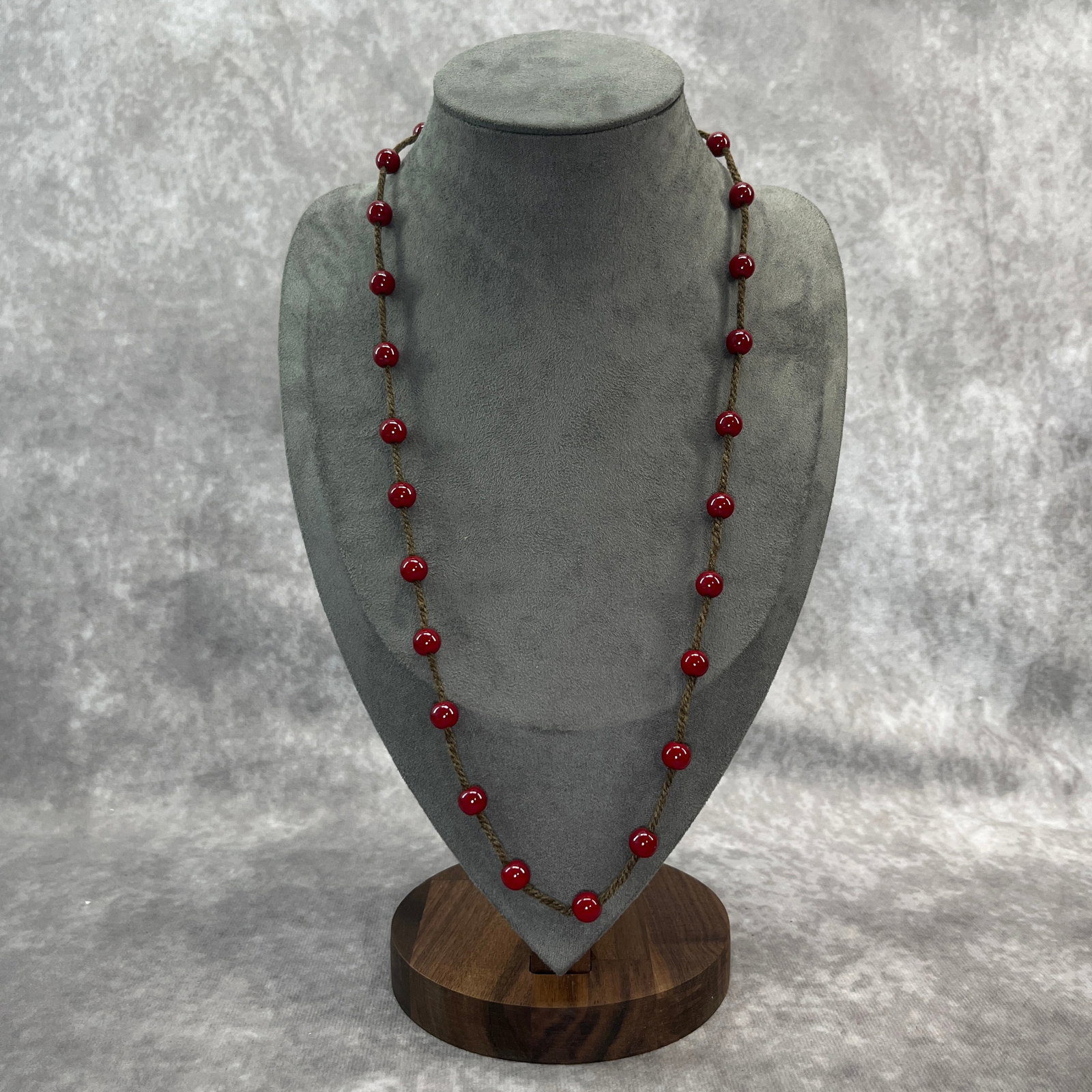 A FINE RED CORAL MADE PRAYER BEAD NECKLACE: Modern; Long: 12.5 inch; Diameter: 0.3 inch; Woodbase for picture and display only