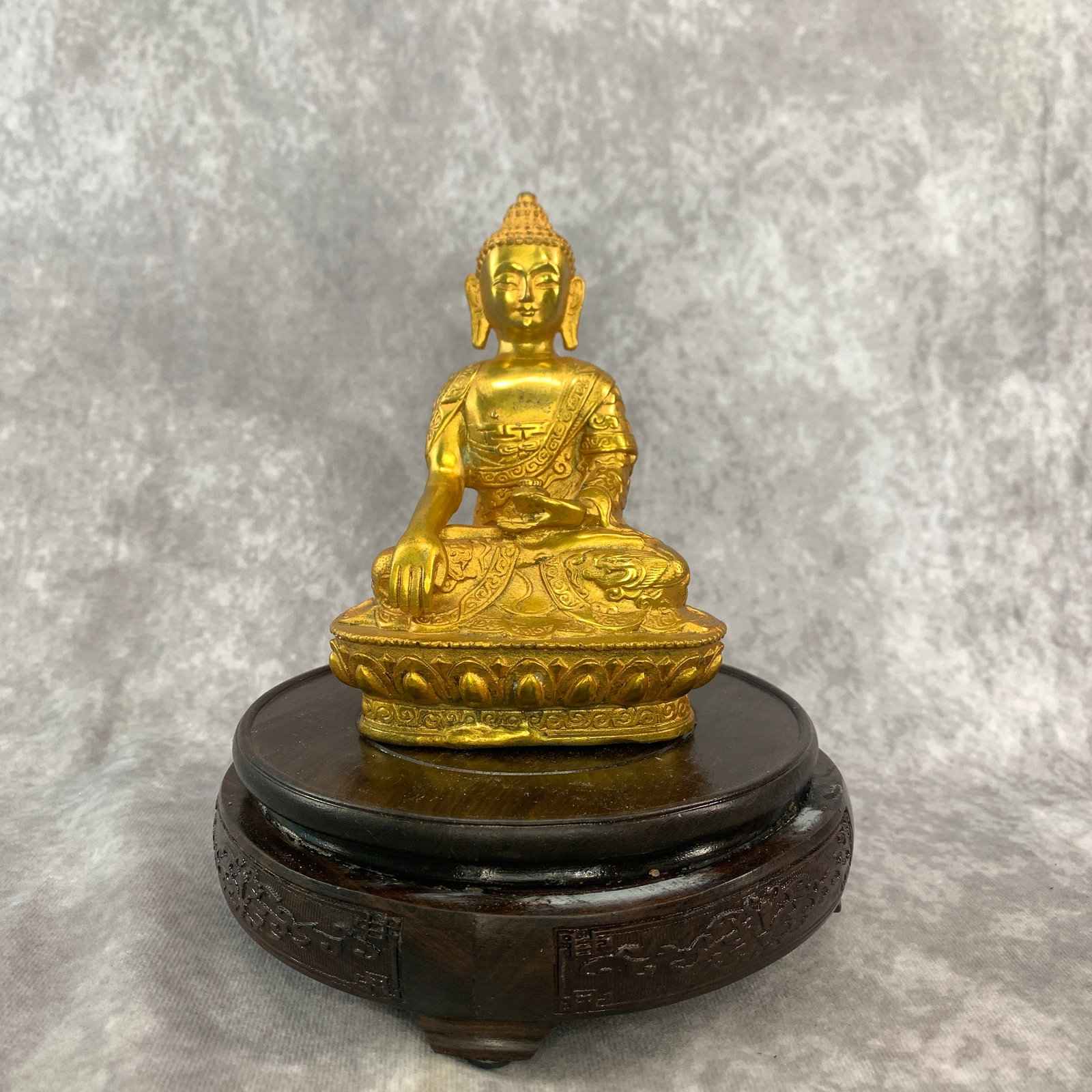 A SMALL GILT-BRONZE SHAKYAMUNI BUDDHA: 20th Century; Long: 6.3 inch; Width:6.1 inch; Heigh: 5 inch; Woodbase for picture and display only