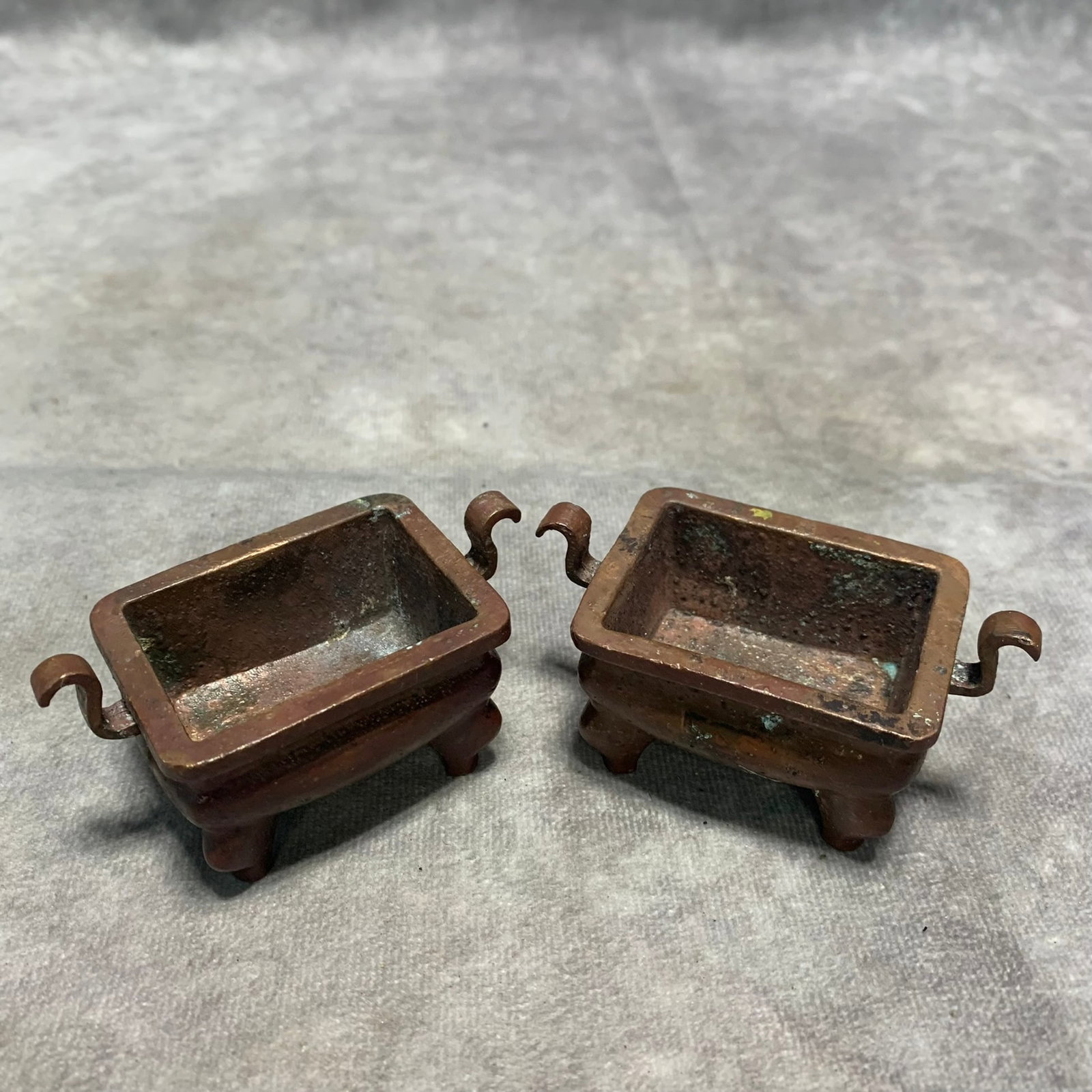 A PAIR OF BRONZE FOUR-LEGGED RUYI-HANDLED CENSERS (1 of 4)